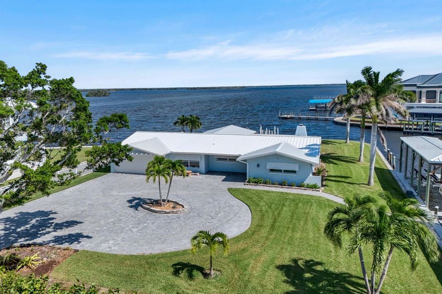 Coastal Waterfront Retreat with Panoramic Estero Bay Views & Gulf Access! Delightfully decorated in a breezy coastal theme, this exceptional 3-bedroom, 3-bath waterfront home offers the ultimate blend of luxury, comfort, and coastal charm. Perfectly situated at the end of a quiet cul-de-sac, this rare property spans nearly ½ acre (.49 acres) and showcases approximately 300 feet of wraparound waterfront along Estero Bay and a scenic intersecting side canal — creating a truly breathtaking backdrop from sunrise to sunset. Beautifully remodeled in 2023, this residence shines inside and out with thoughtful upgrades and high-end finishes. A new metal roof and impact-resistant doors and windows provide lasting peace of mind, energy efficiency, and storm protection. The light-filled interior features an open-concept design that captures sweeping bay views from nearly every room, inviting you to relax and embrace the laid-back Florida lifestyle. Step outside to your private tropical oasis — complete with a heated pool and spa, surrounded by lush landscaping and unobstructed water views. For boating enthusiasts, 2 covered boat lifts and jet ski lifts make it effortless to explore the open water, while a short 10-minute ride to the Gulf of America opens endless opportunities for deep-sea fishing, island hopping, or sunset cruising. Enjoy your morning coffee on the observation pier, cast a line in your backyard, or simply unwind poolside as dolphins and seabirds drift by. The home’s 2-car deep garage offers ample storage and parking for vehicles, golf carts, or beach gear. Inside, you’ll find stylish finishes, and modern lighting that seamlessly blend functionality with coastal elegance. Every detail has been considered — from the smart layout to the thoughtful updates that make this home truly move-in ready. Location is everything, and this one checks every box. You’re just a short stroll to the white sugar-sand beaches, and close to some of the area’s most exciting destinations — including Jimmy Buffett’s Margaritaville Resort, Santini Plaza, Publix, and the newly developed downtown entertainment and dining district. Whether you’re in the mood for live music, fine dining, or boutique shopping, it’s all just minutes away. This home offers something for everyone — boating, fishing, entertaining, or simply soaking in the stunning views. It’s a rare opportunity to own nearly half an acre of prime waterfront in one of Southwest Florida’s most desirable areas. Experience the magic of Estero Bay and the Gulf of America lifestyle — schedule your private showing today!