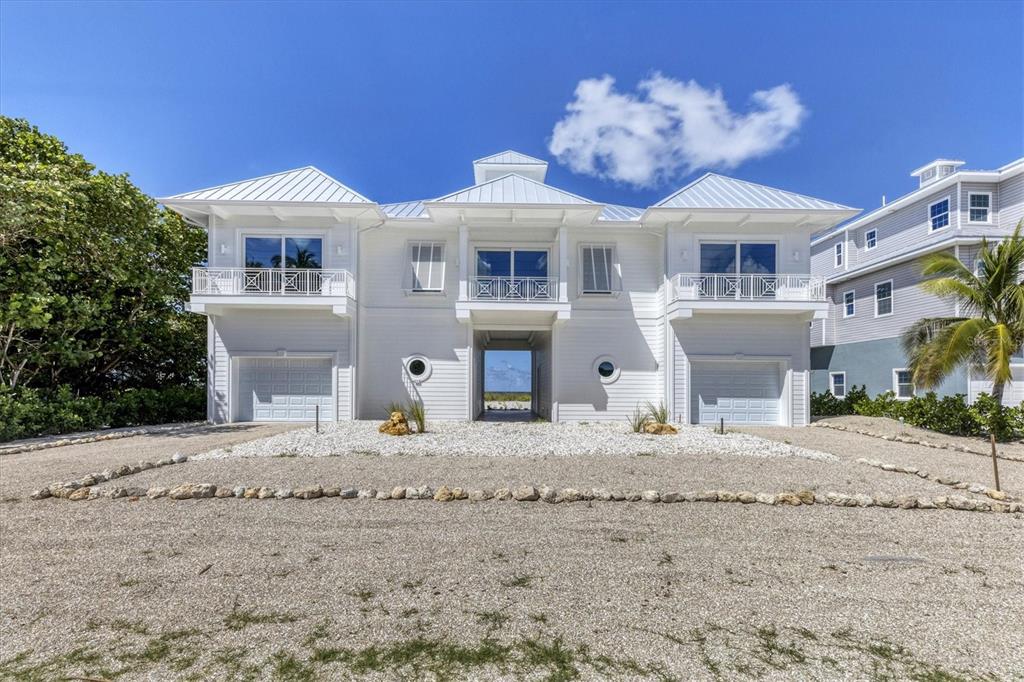 STUNNING BEACHFRONT HOME ADORNING THE COAST OF SOUTHWEST FLORIDA’S “PALM ISLAND” & NEWLY CONSTRUCTED IN 2022. Casual Coastal Comfort meets West Indies flare in this exquisitely designed 4 bedroom, 4 ½ bath residence situated on a 100 ft. wide building site along the beaches of the Gulf of Mexico. Each room offers soaring views, and every bedroom has an ensuite bath which even includes views from the shower! No expense was spared during the design & construction process, and you’ll love the open, airy floor plan which boasts a great room & kitchen that open via tall sliding doors that allow the sea breeze inside and lead to an enormous beachside porch where you can watch the spectacular sunsets each evening. Inside the home, you’ll appreciate the high ceilings, custom millwork, electric fireplace, custom built in shelving in nearly every room, $20K interior electric shutters, recessed lighting throughout and so much more. The exterior offers a gorgeous foyer that leads into the home, low maintenance composite trim & decking, Hardy board siding, “Turtle Glass” on the hurricane rated/impact resistant windows & doors (yes…because we have sea turtles that want to come visit!), 3+ car garage with tons of extra storage space plus golf cart parking….no detail was missed! If you’ve been dreaming about days at the beach and you don’t have the patience to build or renovate…come visit the island and see this magnificent home.
