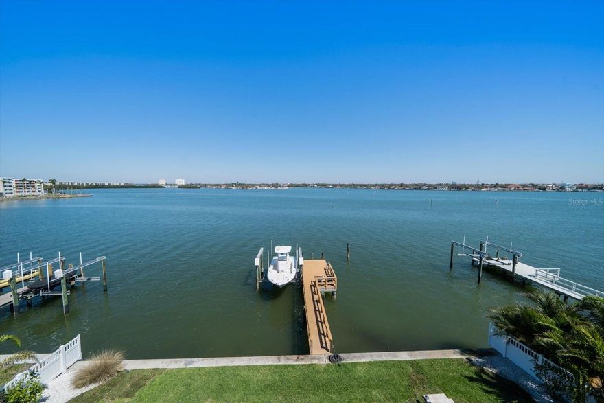 AMAZING PRICE FOR A NEWLY CONSTRUCTED HOME!!  This is your chance to own an exceptional custom-built luxury waterfront home by OASIS, completed in 2022, now priced to attract savvy buyers seeking the perfect blend of design, views, and value. Perched on the picturesque Boca Ciega Bay with over a half-mile of wide open water views, this exquisite residence offers front-row seats to both breathtaking sunrises and spectacular sunsets—all from four custom-designed balconies that were masterfully positioned to maximize every golden moment of the day. Whether you're sipping coffee at dawn or toasting the evening sky, these outdoor spaces are simply unforgettable. Located on peaceful Pasadena Isle—an exclusive waterfront enclave with no through traffic and direct boat access to the Gulf—this home provides the serenity of island living just minutes from the beach, without the beachside congestion. Step inside to an open-concept floor plan flooded with natural light, where clean contemporary lines meet luxurious finishes. The spacious living and entertaining areas flow effortlessly, highlighted by expansive windows that frame those extraordinary water views. This 4-bedroom, 3.5-bathroom residence also includes a private home office with bay views—perfect for remote work or a peaceful retreat. The primary suite is a true sanctuary, with panoramic views, generous space, and his-and-hers custom walk-in closets. The spa-like ensuite bath offers a soaking tub, walk-in shower, dual vanities, with amazing views of the waterways designed in. Additional highlights include: Two family rooms—one on each floor—ideal for entertaining or quiet evenings in. Elevator shaft in place, ready for future installation. Oversized 3-car garage with space for up to 6 vehicles or a mix of storage and recreational gear. A dock with 16,000lb lift for your boat, and a Robalo 246 Cayman available for separate purchase. Resort-style pool and spa, surrounded by lush landscaping and multiple lounging areas. Gas-powered amenities from a buried propane tank: tankless water heater, range, dryer, BBQ, and spa heater. Whole-home water softener and complete AV wiring for smart home systems. This home has been thoughtfully designed to offer an elegant lifestyle centered around light, luxury, and unrivaled waterfront vistas. From sunrise to sunset, inside and out, it’s a rare opportunity to live beautifully on the water. Schedule your private tour today—and prepare to be amazed.
