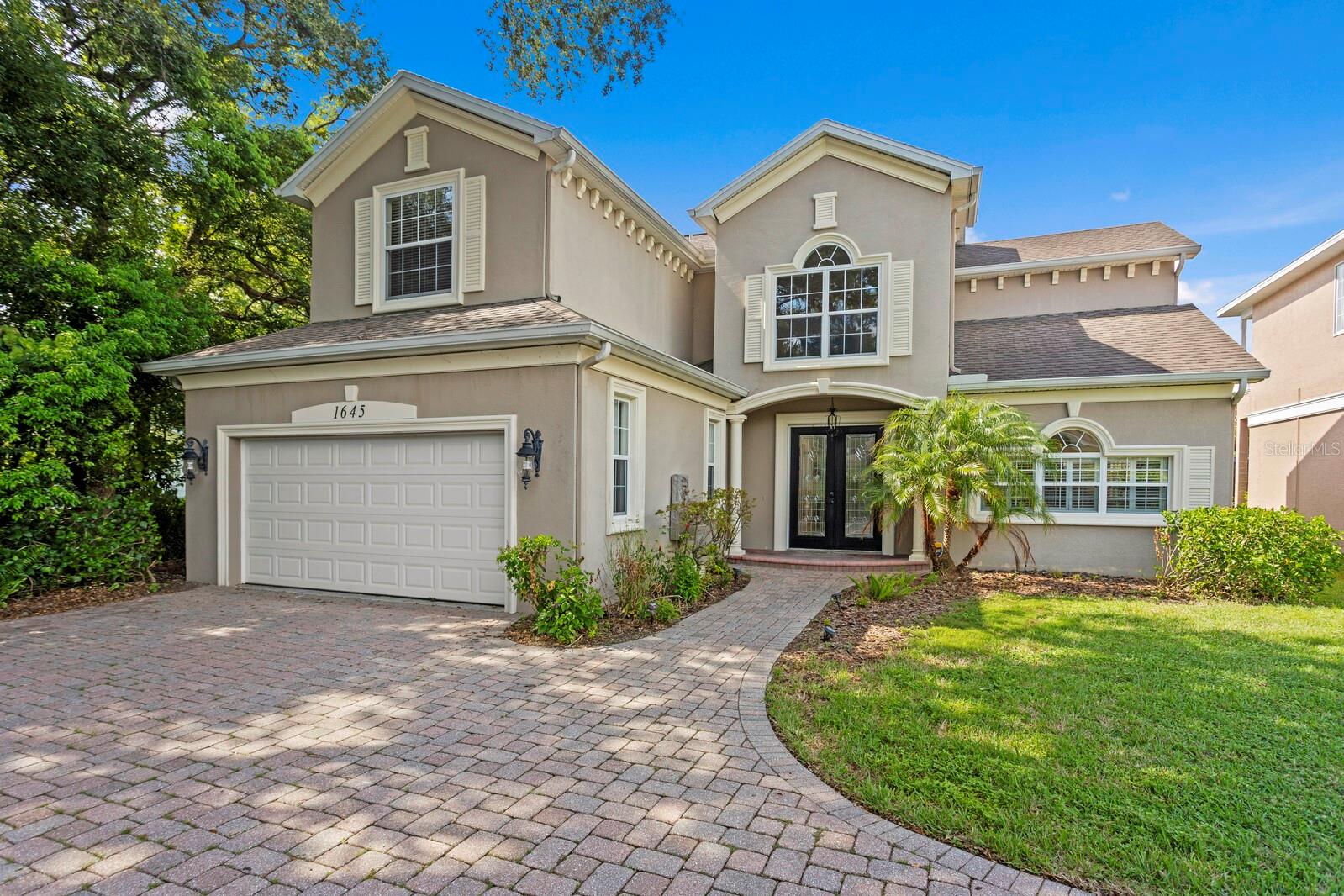 Welcome to a rare opportunity to own a true masterpiece in one of the area’s most private lakefront communities. Tucked behind gates, this custom-crafted lakefront residence is one of only five in an exclusive waterfront enclave—offering the ultimate in privacy, tranquility, and luxury. Step inside to a grand foyer that sets the tone for the entire home, featuring a striking wrought iron and wood curved staircase that makes a dramatic first impression. Vaulted ceilings, double crown molding, and expansive windows and French doors allow an abundance of natural light to pour in, illuminating every refined detail. Designed for both serene living and elevated entertaining, the open-concept floor plan flows seamlessly from the glorious chef’s kitchen with stainless steel appliances into spacious living and dining areas. The first floor luxurious primary retreat boasts double walk-in closets, and a spa-like bathroom with dual vanities. Upstairs, you’ll find a spacious second bedroom, a full guest bath, and a third en-suite bedroom—alongside a flexible bonus space currently used as a home theater, ideal for movie nights, a home office, or a fourth bedroom. Wake up each morning to sweeping, tranquil views of your private lake from your oversized balcony that spans the entire length of the home—perfect for morning coffee, sunset cocktails, or evening gatherings under the stars. Whether you prefer bass fishing, paddleboarding, or kayaking, lake life is right at your fingertips. Outside, a large backyard with room for a pool invites you to create your own tropical oasis. Additional features include a newer AC and hot water tank, an electric vehicle charger, a dedicated laundry room, and NO HOA—a rare luxury in such a well-maintained setting. Perfectly positioned just minutes from Belleair Beach, world-class dining, shopping, theaters, and top-rated schools, this home is also surrounded by abundant recreational options including 163 acre Eagle Lake Park, Largo Central Park, and Highland Recreation Center—offering everything from biking and jogging trails to tennis, basketball, and swimming. This is more than just a home—it’s a lifestyle defined by beauty, privacy, and timeless luxury. Don’t miss your chance to own this one-of-a-kind waterfront retreat.