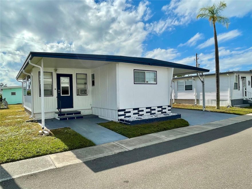 2 bed, 1.5 bath, Florida room home in a well desired 55+ park. This home comes TURN KEY, MOVE RIGHT IN... SHARE is included in list price (valued at $55,000); Home has updated touches through out the home, #1 is the kitchen featuring ample amount of warm wood cabinetry and countertop and backsplash... newer lighted fans in both bedrooms... some updated light fixtures... water heater 2023... Roof is coated every 2 years...  laminate flooring through out, NO CARPET! Much sitting/entertaining area under the covered front patio, side patio surrounded by a privacy fence AND a sitting area added by the seller for some great sunning on the side of the privacy patio. This park is in close proximity to the beaches, airports, I – 275, churches, restaurants, all kinds of shopping, etc.…  very inexpensive living at ONLY...  $183.05 per month which includes all the amenities one could want; WATER, SEWER, and TRASH, owned clubhouse, escrows are fully funded, beautiful heated pool and spa, fitness center, library, shuffleboard, billiard table, and a small lake at the back of the park, laundry room, and your very own private entrance to the super Walmart… on foot, bicycle or golf cart… Etc., etc. GOLF CART may be negotiated.