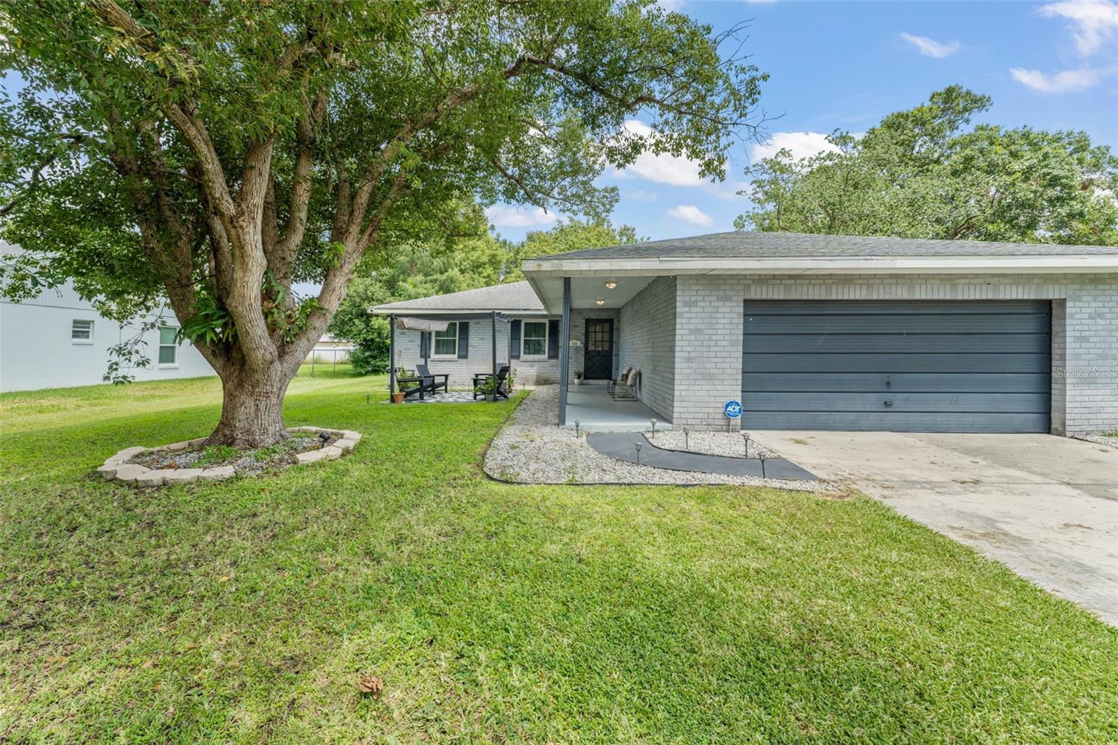 **This house comes with a REDUCED RATE through the seller's preferred lender. This is a lender-paid rate buydown that reduces the buyer's interest rate and monthly payment.** This spacious and move-in-ready single-family home offers nearly 1,600 square feet of well-designed living space with 3 bedrooms, 2 bathrooms, and a 2-car garage. From the moment you arrive, you’re greeted by a charming front yard with a mature shade tree and a custom patio complete with a pergola and retractable shade—perfect for relaxing afternoons or friendly front-porch chats. Step inside to discover a home full of warmth and natural light. A coat closet just off the entry adds convenience, while your eyes are drawn to the spacious living room and newly renovated Florida room at the back of the home. To your right, the completely remodeled kitchen is ready to impress—featuring brand-new stone countertops, sleek cabinetry, a center island with breakfast bar seating, and stainless steel appliances including a new stove, range hood, dishwasher, and waste disposal. A large walk-in pantry with built-in shelving and direct access to the garage makes everyday living extra functional. Adjacent to the kitchen, the dining area flows effortlessly into the living room, creating an open-concept layout that’s ideal for entertaining. French doors lead into the Florida room, now completely renovated with brand-new vinyl flooring and a rebuilt foundation—offering the perfect bonus space for a home office, playroom, or lounge. From here, step outside to the backyard, where a parquet-style patio is already underway and the rest of the yard offers a blank canvas for your outdoor vision. Lush vegetation provides privacy along the back and side of the home, and there's ample space to add fencing or create your dream garden. Down the hall near the entrance, you’ll find the home’s three bedrooms and two fully updated bathrooms. Both guest bedrooms feature vinyl plank flooring and built-in closets, while the bathrooms have been stylishly renovated with new vanities, toilets, mirrors, lighting, and tiled showers. The primary suite offers a peaceful retreat with its own ensuite bathroom, beautifully finished to match the home’s updated design. Additional highlights include: new windows throughout the entire home, an epoxy-coated garage floor, and countless modern upgrades that make this home feel brand new. At 429 Virginia Ave, you’re not just buying a house—you’re finding a place to create lasting memories, gather with loved ones, and truly feel at home. Don’t miss your chance to own this thoughtfully renovated gem in the heart of Saint Cloud.