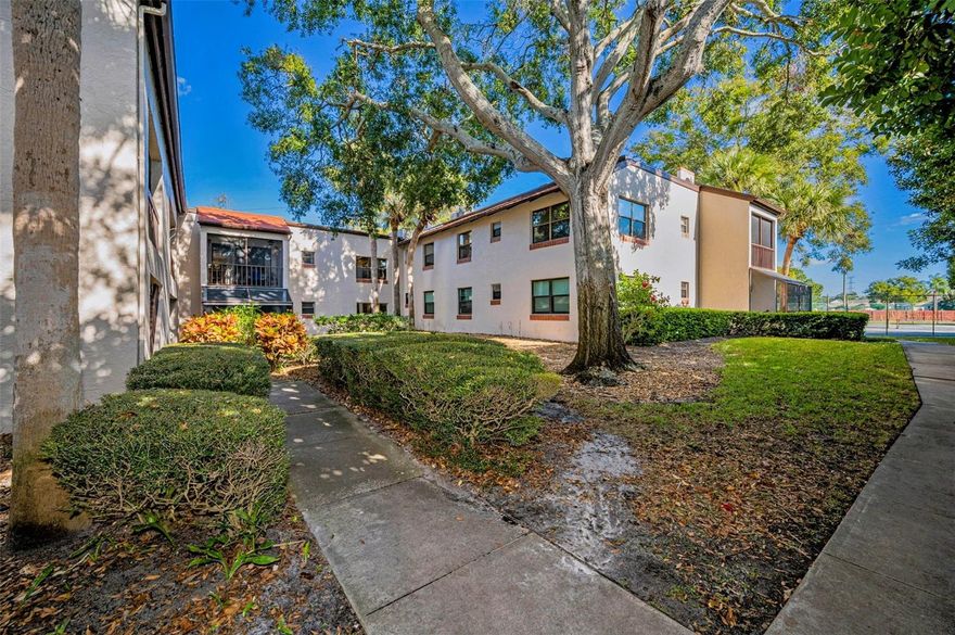 One or more photo(s) has been virtually staged. Experience refined living in one of Clearwater’s most desirable locations. Nestled within the Estancia condominium community, this beautifully updated first-floor residence offers an exceptional blend of comfort, style, and convenience. The thoughtfully designed interior features two spacious bedrooms and two elegantly updated bathrooms, complemented by tile and laminate flooring throughout and an open, split-bedroom floor plan that enhances both flow and privacy. The kitchen has been tastefully upgraded with shaker-style cabinetry, new stainless steel appliances, under-cabinet lighting, and a charming seating area, perfect for a morning coffee. A pass-through to the dining area creates an ideal space for entertaining. Every detail has been considered, including all new interior and closet doors and coordinated bathroom vanities. Step onto the screened-in patio with new screens, offering a serene outdoor retreat. Estancia is a pet-friendly and lease-friendly community, allowing two pets with a combined weight of up to 60 lbs. Residents enjoy access to resort-style amenities, including a cable, community pool and tennis courts, while monthly fees conveniently cover exterior maintenance, water, sewer, trash, grounds care, and the roof which was just replaced in 2025. Ideally situated near great schools, Countryside Mall, Downtown Dunedin, and Safety Harbor, with easy access to major roadways, this residence offers an elevated lifestyle in the heart of Clearwater.