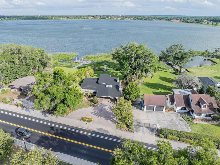 One or more photo(s) has been virtually staged. Welcome to an exceptional lakefront retreat on highly sought-after Lake Hollingsworth! This beautifully updated 4-bedroom, 3.5-bathroom home blends comfort, style, and breathtaking waterfront living. Thoughtfully improved in 2025 with a new roof, updated electrical and plumbing systems, new gas water heater, the home also features rich hardwood floors throughout, a whole home generator, and two working gas fireplaces.

Designed to capture natural light and stunning views, the upstairs living room, dining room, and sunroom showcase impressive floor-to-ceiling windows overlooking the lake. The sunroom, complete with skylights, is the perfect space to relax or entertain year-round.

The updated kitchen flows seamlessly into the main living areas, while an additional downstairs kitchen and living room provide an ideal setup for guests, extended family, or flexible living arrangements.

The spacious primary suite offers a private balcony overlooking the lake while a versatile bonus room can serve as a fifth bedroom, office, media room, or playroom.

Step outside to a large patio, expansive backyard, and private dock—perfect for boating, fishing, or enjoying peaceful lakefront sunsets.

Don’t miss this rare opportunity to own a stunning waterfront property in one of Lakeland’s most desirable locations!