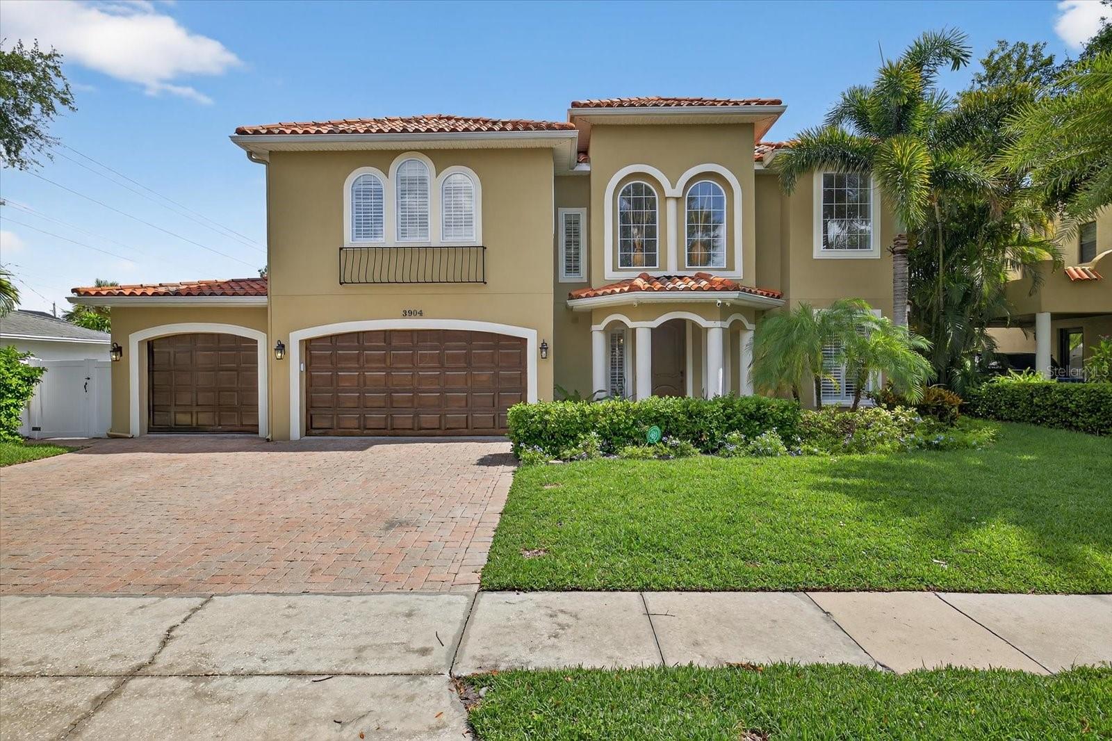 Enjoy the best of South Tampa living in this beautifully upgraded Mediterranean-style Pool home, built in 2007 and meticulously maintained with spectacular outdoor living space. The flexible floor plan is designed to suit a variety of lifestyles, starting with a stunning two-story foyer and living room featuring a welcoming gas fireplace.
Adjacent to the living room, the elegant dining area is ideal for hosting both intimate dinners and larger gatherings. The gourmet kitchen seamlessly flows into the family room and breakfast nook, and boasts granite countertops, rich wood cabinetry, stainless steel appliances, including a gas cooktop and hood. French doors in the family room open to a covered lanai with a fully equipped outdoor kitchen—perfect for entertaining or relaxing in the lush, private backyard. A cozy fire pit adds charm and warmth on cooler evenings. The downstairs sixth bedroom with en-suite bath provides a comfortable space for extended guests or makes an ideal home office. Upstairs, the oversized primary suite offers dual closets and a spa-inspired bathroom with both soaking tub and separate shower. Four additional bedrooms on the second floor provide versatile living options to suit your needs.