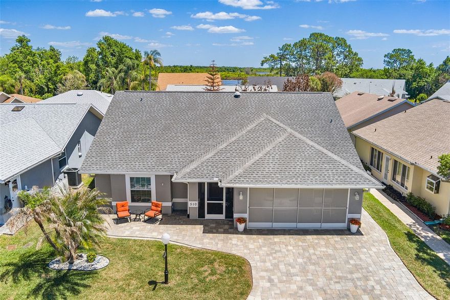 A DREAMERS DELIGHT! This lovely, spacious and light and bright 2BR/2BA home with an open floor plan is located in The HIDDEN JEWEL, Lake Henry Estates, an Active 55+ Gated and Resident Owned Community with so much to offer! As you approach the home, note the attractive paver driveway and inviting front patio area! Sit a while and enjoy talking with neighbors as they stroll by! The screened front entry offers a place to sit while enjoying that morning cup of coffee or tea while listening to the birds sing. Note the beautiful front entry door that has leaded and beveled glass as you enter the home. Attractive laminate flooring and a light wall paint color provide an easy backdrop for decorating. This "Barbados" style home has an open and very appealing floor plan . The kitchen has wood cabinetry with lower cabinet pullouts, plenty of counter top space, deluxe stainless steel appliances, SS sink with updated faucet, pantry closet and a breakfast bar. The adjoining dining area features 2 closets! The spacious great room with vaulted ceiling leads to a multipurpose Florida room! Step outside the Florida room and there is a large patio area to enjoy! There are actually two bedroom suites in this home. The primary ensuite bathroom has dual sinks and has been updated with a gorgeous walk in shower! Sliding screen garage doors allow for air flow throughout the garage!Updates include the following: new AC/Heat system  fall 2025; upper breakfast bar cabinetry and dated drop kitchen ceiling removed and spot lighting installed; exterior repainted 2024; paver driveway/patio area resealed 2024; attractive laminate flooring installed 2023; roof replaced 2020; paver driveway and patio area installed 2020; dual pane energy efficient windows installed throughout; and more!!! The seller will assign the buyer one voting share in the Sweetwater East Investment Co after closing. The monthly maintenance fee includes 8000 gallons of water, sewer, internet, cable TV, & use/care of most amenities. Trash removal is included in your taxes. Community amenities include a 12,000 SF clubhouse w/library, pub, ballroom, gym & billiards room; social activities; 9-hole executive golf course; heated pool & spa; tennis, pickle ball & shuffleboard courts; WOODWORKING SHOP; RV STORAGE; & BOAT DOCKAGE. This conveniently located community is close to shopping, medical clinics, hospitals, HWY 27 and I-4! Easy access to Tampa, Orlando, beaches & area attractions. 55+ COMMUNITY, (MINIMUM AGE 40). MAY HAVE 2 PETS UP TO 20# EACH. $300 ONE-TIME FEE FOR NEW RESIDENTS. All information and measurements are believed to be accurate but not guaranteed and should be verified by the buyer.