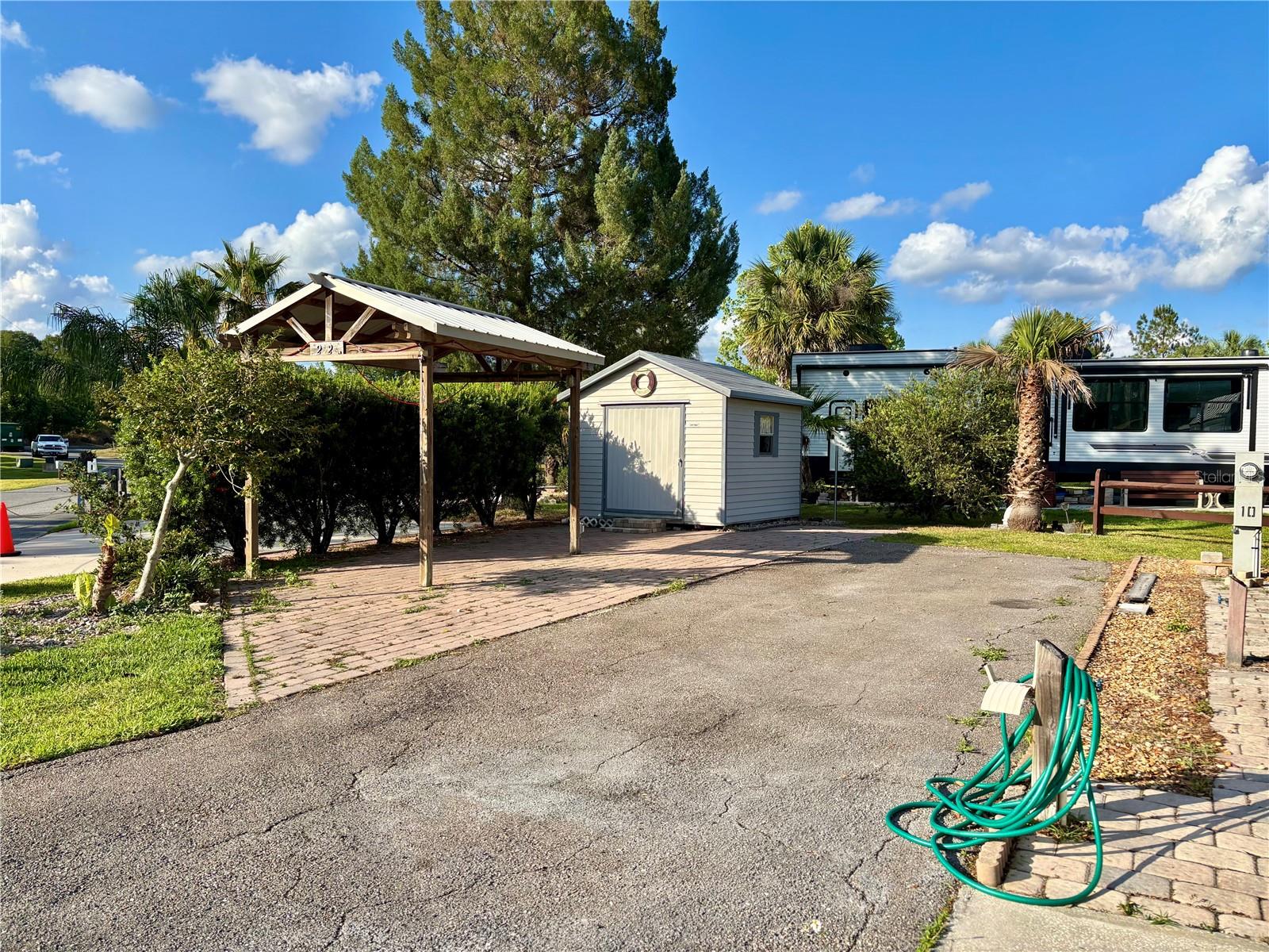Vacant RV Lot in The Village at Wilderness RV Park – 55+ Community – Loaded with Extras!
Discover your perfect Florida retreat in the highly desirable Village at Wilderness RV Park, a vibrant 55+ community that blends tranquility with convenience. This beautifully maintained vacant RV lot is ready for your RV and outdoor living dreams.
Property Highlights:
Spacious RV-ready lot,
Pergola with paver patio – perfect for relaxing or entertaining outdoors,
Storage shed included – ideal for storing tools, outdoor gear, or seasonal items,
Landscaped and well-kept surroundings.
Enjoy the Florida lifestyle year-round with access to community amenities like a swimming pool, hot tub, fitness center, shuffleboard courts, nature trails, and social events. Whether you're a seasonal snowbird or a full-time resident, this lot offers comfort, convenience, and a sense of community.
Don't miss this opportunity to own a slice of paradise in one of Florida’s premier 55+ RV communities!
Direct access to the Ocklawaha River and Florida Greenway Trails for kayaking, fishing, hiking, and biking.
The HOA fee covers sewer, water, trash, private roads, grounds maintenance, and full access to all community amenities—making life easy and worry-free.
Located just minutes from Silver Springs State Park, shopping, dining, and historic downtown Ocala, with East Coast beaches just an hour away, this is the perfect place to enjoy the best of Florida living. Your dream lot is waiting—schedule your showing today!
Please note: you own the land and the lot is deeded in your name.