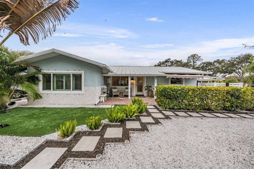 An exceptional opportunity to own this fully renovated, energy-efficient 3-bedroom, 2-bath residence with an oversized 3-car plus detached garage, perfectly positioned on nearly one-third of an acre in one of Pinellas County’s most vibrant and sought-after communities. Thoughtfully redesigned from top to bottom, this home blends modern luxury with long-term durability and efficiency. As you enter off the circular driveway and through the glass front door, a bright, open-concept layout greets you, featuring elegant tile and luxury vinyl wood-look flooring throughout. The 2021 designer kitchen showcases white wood shaker cabinetry with custom pull-out storage, a built-in pantry, quartz countertops, a striking custom tile backsplash, stainless steel appliances, and a convection oven—ideal for both everyday living and entertaining. The primary suite is a private retreat, offering a spa-inspired bathroom with a new vanity and countertop, a large tiled walk-in shower, premium fixtures, and a spacious walk-in closet. The guest bedroom and secondary bathroom have also been updated with new flooring, new vanity, and upscale finishes. The third bedroom offers complete privacy and an oversized walk-in closet, located on the opposite side of the home—perfect for guests, home office, or multigenerational living. Just off the dining area, a large interior laundry room leads to the screened lanai. From there, step outside to a sprawling, resort-like fenced backyard featuring paver patios, a Trex deck behind the garage with a newly built pergola, firepit area, new landscape lighting, and ample space to add a resort-style pool. The impressive detached 3-car garage offers abundant storage, a custom-built game room, hurricane-rated doors, front and rear access, and the flexibility to easily convert a portion into a guest house or in-law suite. Three additional storage sheds also convey. This home is loaded with premium infrastructure upgrades including a fully owned solar electric system (average electric bill approximately $40), metal roof and soffits (2015), high-efficiency A/C (2019) with blue light filter, Icynene insulation, hurricane-rated low-E windows and doors, natural gas with on-demand water heater and gas dryer, new PVC plumbing throughout, new stucco and exterior paint on both the home and garage, and a transfer switch with natural gas hookup for a portable generator. Additional improvements include new interior doors, molding and baseboards, upgraded whole-home lighting, and new front and rear landscaping with irrigation system and shallow well pump. Golf cart friendly with direct access to Downtown Dunedin and ideally located near the Pinellas Trail, Honeymoon Island, Historic Dunedin Golf Course, a splash park, Dunedin community center and community pool, highlander park, Hammock Park, world-class beaches, championship golf, shopping, dining, and Tampa International Airport—this is a rare turnkey estate combining lifestyle, luxury, and long-term value. Home is in a NON FLOOD ZONE!