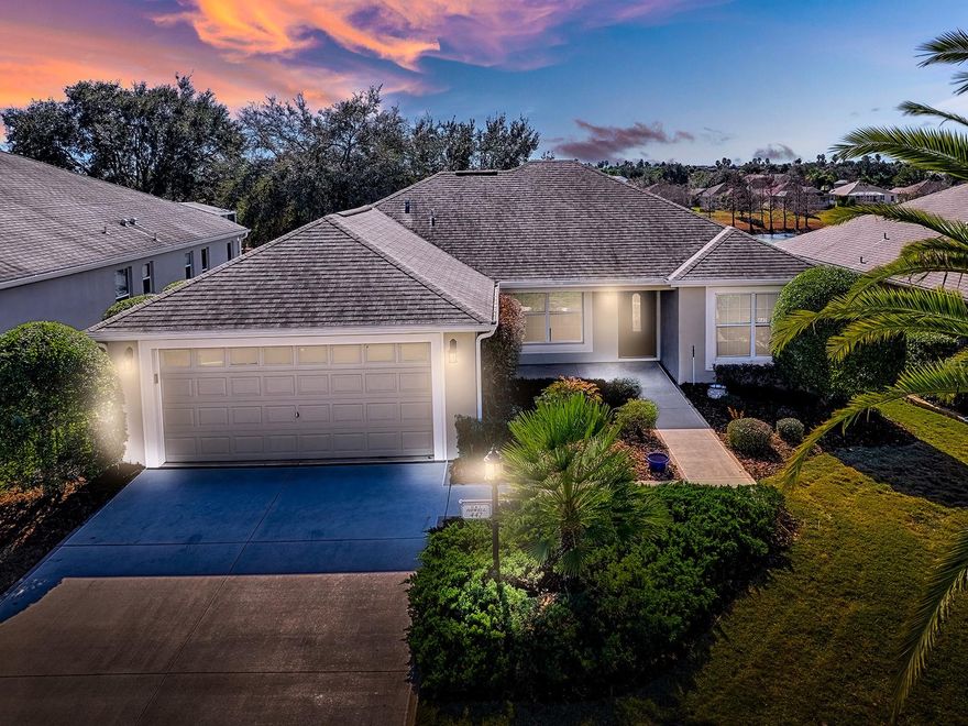 Welcome to the lovely Village of Amelia, located within easy access to Spanish Springs, Lake Sumter Landing and Brownwood Town Square.   The Allamanda designer model home with a beautiful water view off the all season Florida Room offers everything one needs to enjoy the active 55+ lifestyle here in The Villages. The property is conveniently located near key amenities, including a hospital, medical facilities, shopping, and restaurants along 446 and 446A. These conveniences ensure that daily needs and healthcare services are easily accessible, giving you time to enjoy the leisurely pursuits and social activities that this community offers. Coming inside, you're greeted by vaulted ceilings that create an airy and spacious atmosphere. The home's layout features three bedrooms and two bathrooms, thoughtfully designed to promote both privacy and togetherness. The split bedroom plan provides a tranquil retreat in the primary suite, a generous walk-in closet and glass enclosed shower in the Primary Bathroom.The living area is perfect for entertaining with large diagonal tile. No carpet offers a clean sense throughout. Adjacent to the living room, the dining area offers a great entertaining space to dine in comfort with and guests enjoying delicious meals, and so accessible from the kitchen.   One of the best and perfect features of this home is its beautiful Florida Room with a  water view, a perfect space for unwinding with a book or hosting friends. Natural light pours in, enhancing the open feel and inviting the outdoors inside. Outside, enjoy the beautiful landscaping meticulously maintained  Roof, inviting front porch and well-manicured landscaping. It’s the perfect spot for enjoying a morning coffee or chatting with neighbors.  There is even space outside for a grill and seating to enjoy the Florida weather.  The practical aspects of the home haven’t been overlooked either, with a two-car garage featuring an epoxy floor coating, offering durability and an appealing finish. Living in the Village of Amelia means you're not just buying a home; you're becoming part of a warm and friendly community. Enjoy the nearby recreation centers, which provides ample opportunities for socializing and keeping active. Whether it's a leisurely stroll around the neighborhood greeting neighbors or dining at the local restaurant, there’s something for everyone. It’s not just a place to live; it's a lifestyle. Experience a new chapter in this vibrant community, where every day offers something exciting and new.