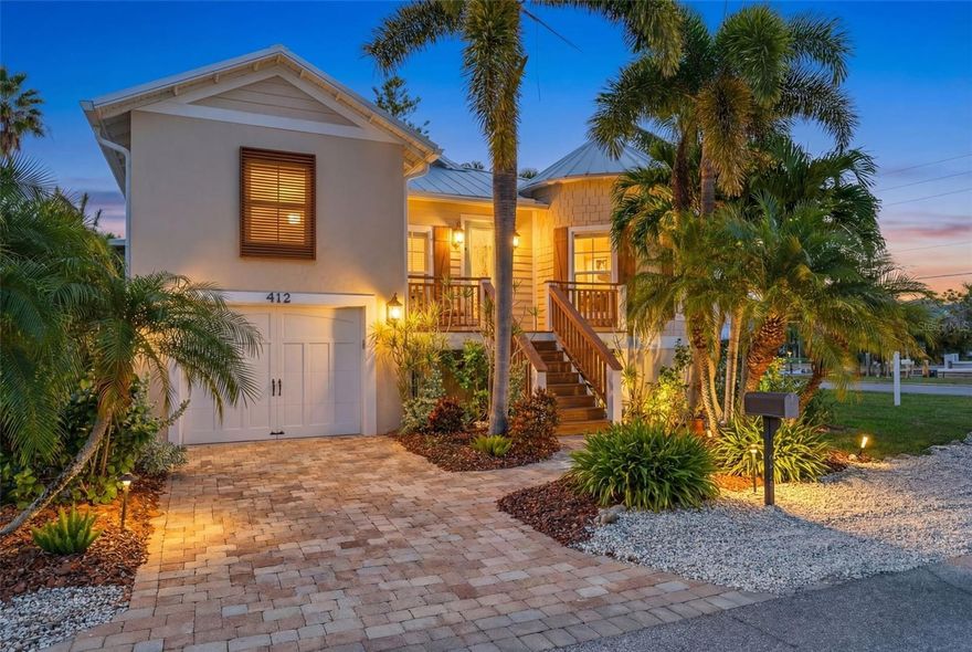 A rare find on Anna Maria Island, this elevated coastal home sits on an expansive 10,000+ square foot corner lot, offering exceptional privacy on multiple sides, an uncommon feature in the heart of Holmes Beach. Enhanced by a new metal roof (2025), newer air conditioning system (2022), storm-rated impact windows and doors, and a newly resurfaced heated pool (2025), this home offers true peace of mind and resort-style living. With weekly rental zoning, this Anna Maria Island real estate opportunity is offered fully turnkey furnished, has recently operated as a short-term rental, and is located just 3 blocks from Anna Maria Island’s sugar sand Gulf Beaches. A perfect blend of island lifestyle with strong investment flexibility. Centrally located in Holmes Beach FL, this quiet neighborhood home is close to restaurants, shopping, coffee shops, and many island attractions. This custom home is far from “cookie cutter.” Custom features include an open-concept layout with 9.5-foot ceilings, soaring tray accents, abundant natural light, luxury vinyl flooring, brand-new carpet in bedrooms, plantation shutters, and a distinctive round formal dining room that captures peaceful and picturesque views down the canal. The chef’s kitchen offers granite countertops and a spacious breakfast bar flowing into the great room, perfect for family nights or an evening of entertaining guests. The private primary suite includes an en-suite bath, a walk-in closet, and continued picturesque views of the canal. Both the primary and additional bedrooms feature built-in closet shelving and organizational systems for added ease. Step outside to a truly rare find in Holmes Beach: an oversized, completely private backyard oasis designed for ultimate relaxation. The outdoor experience begins on the elevated deck, offering the perfect vantage point over the sparkling heated pool, an ideal spot for morning coffee or evening cocktails. Below, a resort-style sunbathing terrace invites you to soak up the sun with plenty of room for intimate outdoor dining or entertaining family and friends. Fully fenced and finished with lush tropical landscaping and low-maintenance artificial turf, this expansive retreat provides the space and privacy rarely found in this area. The property offers convenient access to Sarasota-Bradenton International Airport approximately 40 minutes away, Tampa International Airport about 60-70 minutes, and IMG Academy roughly 25 minutes from the island. Plus a Holmes Beach bonus with City of Holmes Beach boat slip rentals available directly across the street on a first-come, first-served annual lease basis (currently waitlisted) for approximately $750/year.