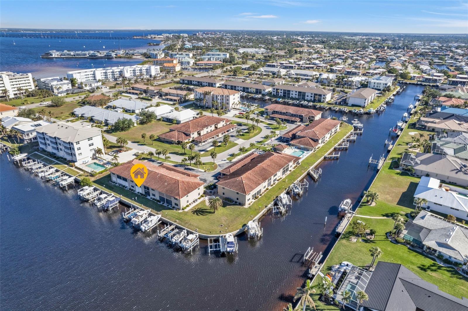 Ground level (NO STEPS), 2 bedroom, 2 bathroom split floor plan COMPLETELY UPDATED, with a DEEDED BOAT SLIP, concrete dock and 10,000 pound BOAT LIFT with remote outside your back lanai door. NO PET RESTRICTIONS FOR OWNERS. This home is setup as a SMART HOME to control your keyless front door lock and Nest thermostat remotely. All brand new LUXURY VINYL FLOORING, interior paint, cabinets, sinks, countertops, toilets, lighting, and ceiling fans. The great room is connected to the lanai that has two sliders (one from the great room and the other from the master bedroom) to access Florida lifestyle living. The master bathroom has a walk in shower. The lanai has an OVERSIZED DOUBLE DOOR FROM FLOOR TO CEILING STORAGE SPACE that is three feet deep for ample storage. The laundry room has plenty of storage and a full size washer and dryer. The condo has HURRICANE SHUTTERS for all windows and a motorized shutter for the lanai. There is a deeded CARPORT steps away from your front door for added convenience. The complex has a NEW METAL ROOF and NO ASSESSMENTS. WATER IS INCLUDED in your HOA monthly billing. There is a community area that has a sitting space with a grill to cook your favorite foods on. Sea Isles is situated in a prime location with a short walk to Fisherman's Village and downtown Punta Gorda. HOUNDS ON HENRY DOG PARK is less than a mile down the road. Plenty of walking and biking trails surrounding the area. Concrete sea walls are maintained by the City of Punta Gorda. The water out time by power boat is just a few minutes to Charlotte Harbor.
