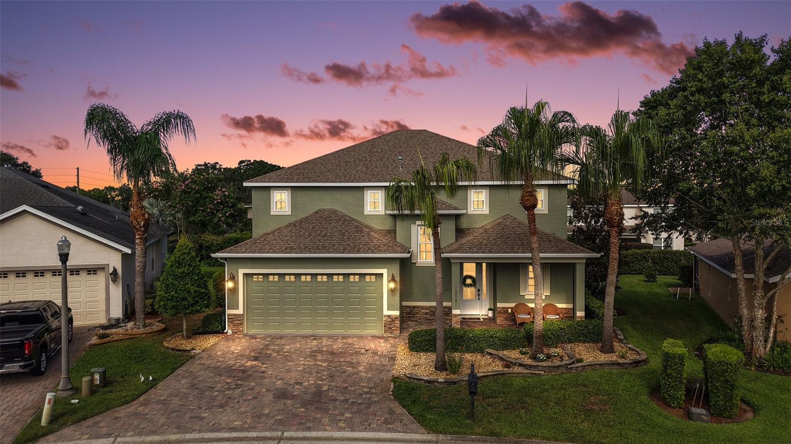 FABULOUS 4-Bedroom 3 1/2-Bath BLOCK and STUCCO home with ENORMOUS BONUS ROOM, IMMENSE BIRDCAGE, and PRIVACY LANDSCAPING nestled on a LARGE PIE-SHAPED LOT in the highly sought-after GATED community of Lakeside Landings - amenities include a lagoon-style pool, hot tub, state-of-the-art clubhouse, and fitness center! Enjoy MAINTENANCE FREE LIVING with HOA-COVERED lawn care, irrigation, trash, and pest! JUST MINUTES from The Villages retirement community, The Villages Charter Schools, and CR466 offering easy access to a plethora of shopping, dining, banking, medical and more! The STRIKING exterior screams curb appeal with lush tropical landscaping, curved stacked walls, and PAVER drive and walkways. A quaint FRONT PORCH and beautiful GLASS front door with sidelight welcomes you in to the generous foyer. Soaring 13’ HIGH ceilings and TILE flooring grace the VOLUMINOUS living, dining and kitchen areas. The OPEN-CONCEPT offers a SPACIOUS layout that connects these rooms for effortless entertaining and everyday living! From the living room, sliding glass doors invite you in to the EXPANSIVE lanai and birdcage with PRIVACY landscaping. This SPACIOUS OUTDOOR RETREAT is perfect for everything - Whether you're hosting friends and family or simply savoring a quiet morning coffee - It’s truly an entertainer’s dream and a PRIVATE sanctuary all in one! Back inside, the STUNNING GOURMET kitchen boasts pristine CHERRY cabinetry, GRANITE countertops, GLASS TILE backsplash, STAINLESS appliances, EAT-IN breakfast bar, and PANTRY closet. The luxurious primary bedroom features beautiful RICH WOOD LAMINATE flooring, HIGH ceiling, and a WALK-IN closet. Its en-suite bathroom offers TILE flooring, CHERRY cabinetry, DOUBLE sinks, WALK-IN TILED ROMAN-STYLE shower, and a separate water closet. For added CONVENIENCE, there’s also an additional HALF-BATH with two hallway STORAGE closets just off of the living room. Venture upstairs to discover three more bedrooms and two baths! Bedroom two features a built-in closet and an EN-SUITE bathroom with CHERRY cabinetry and a TILED tub and shower combination. The third and fourth bedrooms both have built-in closets and are conveniently connected by and HUGE Jack-and-Jill style bathroom. This amazing bath boasts TWO separate CHERRY vanities, TILED WALK-IN shower, and a LINEN closet. But wait, there’s more! There’s also an ENORMOUS BONUS ROOM for endless possibilities! This FANTASTIC MULTIPURPOSE SPACE offers limitless potential for your lifestyle needs. Whether you're dreaming of a state-of-the-art home theater, a spacious playroom, a home gym, or even a multi-station office setup, this oversized flex space is ready to become whatever you envision! The GENEROUS laundry room is centrally located on the second floor and features WHITE cabinetry and a utility sink. Back downstairs and completing the package is a 506sf two-car garage boasting a HUGE under-stairway storage closet and plenty of space for parking! WITH SO MUCH TO OFFER- THIS HOME IS A MUST SEE! The Lakeside Landings community offers INCREDIBLE AMENITIES! Soak up the sun or take a refreshing dip in the RESORT-STYLE POOL! Workout in the FITNESS CENTER or enjoy a game of TENNIS or PICKLE BALL! There’s even a PLAYGROUND, BEACH AREA and FISHING DOCK with access to BEAUTIFUL Lake Miona! DON’T MISS YOUR OPPORTUNITY TO MAKE THIS FABULOUS HOME in an AMAZING LOCATION YOUR OWN! Please watch our walkthrough video and call today to schedule your Private Showing or Virtual Tour!