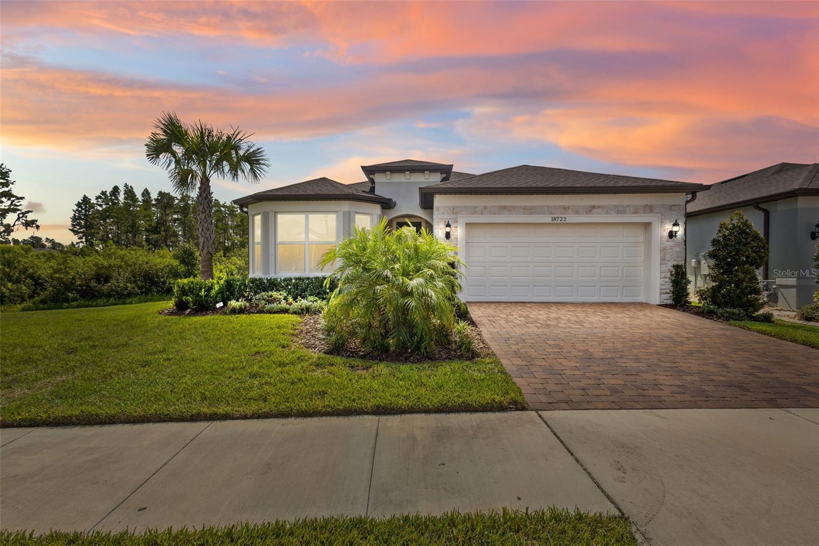 One or more photo(s) has been virtually staged. You’re not going to find another one like this. This is the Mystique floor plan—one of the most popular layouts in all of Del Webb Bexley—and it’s sitting on one of the best lots in the entire community. It’s private, it’s peaceful, and it’s perfectly positioned on a quiet dead-end street with conservation views on two sides and only one side neighbor.
The layout is ideal for many homeowners: not too big, not too small. Two bedrooms, two full baths, a den with French doors, and a 3-car tandem garage—which is rare. The home is incredibly bright thanks to the way it’s positioned on the lot, and it has that seamless indoor-outdoor feel everyone wants. The zero-corner sliding doors open all the way up to a huge extended screened-in lanai and a backyard that offers both space and privacy.
Inside, the flooring is luxury vinyl plank throughout—no carpet anywhere—and the whole home has a clean, timeless feel. The kitchen features light cabinetry, quartz counters, stainless KitchenAid appliances, a gas range, and a large island that flows into the living and dining areas. The living room is filled with natural light, and the view from there is exactly what you want in Florida—lush conservation without another home in sight.
The primary suite is tucked in the back of the home, with great views, double vanities, a big walk-in shower with a bench, and a generous walk-in closet. Up front, you’ll find a spacious guest bedroom and full bath, and that versatile den—perfect for an office, craft room, or whatever suits your lifestyle.
And of course, this is Del Webb Bexley—one of the top 55+ communities in Tampa Bay. You get a 19,000 square foot clubhouse with a resort-style pool, fitness center, bistro, craft and card rooms, pickleball, tennis, bocce, a dog park, walking trails, and a full calendar of events thanks to the on-site lifestyle director.
If you’ve been waiting for the right home in Del Webb Bexley—this is it.
