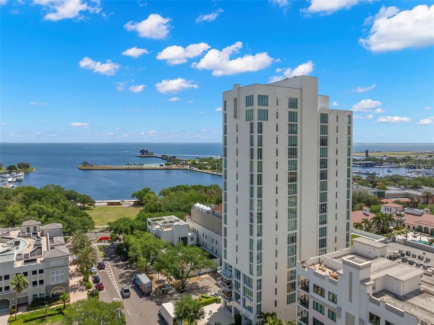Welcome to Bliss, this beautifully updated, move-in-ready condo in one of downtown St. Petersburg’s most exclusive boutique residences. This meticulously customized home combines modern upgrades, designer touches, and exceptional comfort in a premier waterfront setting. This expansive 3-bedroom, 2.5 bath residence offers 2,120 square feet of thoughtfully designed living space with a split floor plan. A private elevator lobby opens to the entry foyer, leading into a spacious living and dining area with floor-to-ceiling glass walls and motorized shades. Enjoy breathtaking, unobstructed views of Tampa Bay, the St. Petersburg Pier, and marina, along with the vibrant energy of Beach Drive. A terrace extends the interior outdoors, creating seamless indoor-outdoor living. The well-appointed kitchen features Viking appliances, including a gas range and hood, new dishwasher, quartz countertops and custom cabinetry. The great room is enhanced by an electric fireplace and thoughtfully designed features, including a hidden door leading to a dedicated storage room. The primary suite offers expansive views and a spacious layout with motorized shades, walk-in closet, en-suite bath appointed with dual vanities, a soaking tub, and a walk-in shower with bench. Recent enhancements include updated ceiling light fixtures throughout, fresh interior paint in the primary bedroom, new furniture, accessories, and rugs in the primary bedroom, guest bedroom, and den as well as new shades in the primary bathroom, guest bathroom, and guest bedrooms. The residence includes two assigned parking spaces within the secure car elevator garage. With just 29 exclusive residences, Bliss offers exceptional privacy – only two units per floor, private elevator access, and no shared walls. Amenities include concierge service, guest parking, fitness center, dog walk area, heated swimming pool, and an on-site manager. Take in the views from the top-floor Sky Lounge while relaxing on the terrace or enjoying the hot tub. Bliss is ideally located in the heart of downtown, just steps from world-class dining, boutiques, museums, waterfront parks, the Pier, Vinoy Park, and water taxi access to downtown Tampa. Nearby North Shore Park offers a dog park, aquatic center, tennis and beach volleyball courts, playgrounds, and year-round community events. This is a rare opportunity to own an exclusive and stunning waterfront residence in one of St. Petersburg’s most coveted luxury buildings – schedule your private showing today!