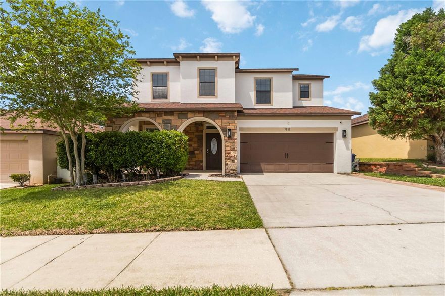 One or more photo(s) has been virtually staged. Welcome to this stunning two-story 5-bedroom, 3-bath home in the highly desirable Minneola Reserve community, where style, comfort, and thoughtful upgrades come together beautifully. From the moment you arrive, the exceptional curb appeal stands out with elegant stone accents, a covered front porch, paver driveway, and beautifully maintained landscaping.

Step inside to discover an inviting open-concept layout filled with extensive cosmetic upgrades throughout, including gorgeous hardwood flooring, designer lighting, upgraded finishes, and stylish details that make this home truly move-in ready. Just off the foyer, the downstairs bedroom offers the flexibility to serve as a private guest suite, home office, or study.

The heart of the home is the beautifully upgraded kitchen, featuring abundant granite counter space, a spacious center island, stainless steel appliances, 42-inch cabinetry, upgraded backsplash, custom lighting, and an impressive walk-in pantry with custom shelving. A convenient drop zone adds everyday functionality, while the seamless flow into the great room creates the perfect space for gathering and entertaining. The living area is enhanced by a built-in electric fireplace, adding warmth ambiance.

Upstairs, you’ll find four generously sized bedrooms, including a spacious and light-filled primary suite featuring oversized picture windows and an elegant tray ceiling, adding architectural charm and an elevated sense of luxury.

Step outside to your private fenced backyard retreat, ideal for relaxing or entertaining, complete with a large covered lanai and a pavered fire pit area perfect for evenings under the stars. Residents of Minneola Reserve also enjoy access to a beautiful community pool, offering the perfect place to unwind and enjoy Florida living.

Perfectly positioned for both convenience and lifestyle, this home is located in a charming community with quick access to the Florida Turnpike, making travel to surrounding areas simple and efficient. You’ll appreciate being just minutes from popular shopping, great restaurants, daily conveniences, scenic parks, and highly rated schools—bringing comfort and practicality to everyday living.

Offering the ideal combination of upgraded modern style, timeless comfort, and an unbeatable location, this exceptional Minneola home presents a rare opportunity to enjoy space, sophistication, and community in one beautiful package. With its thoughtful enhancements and desirable setting, this is truly a home that stands out from the rest.