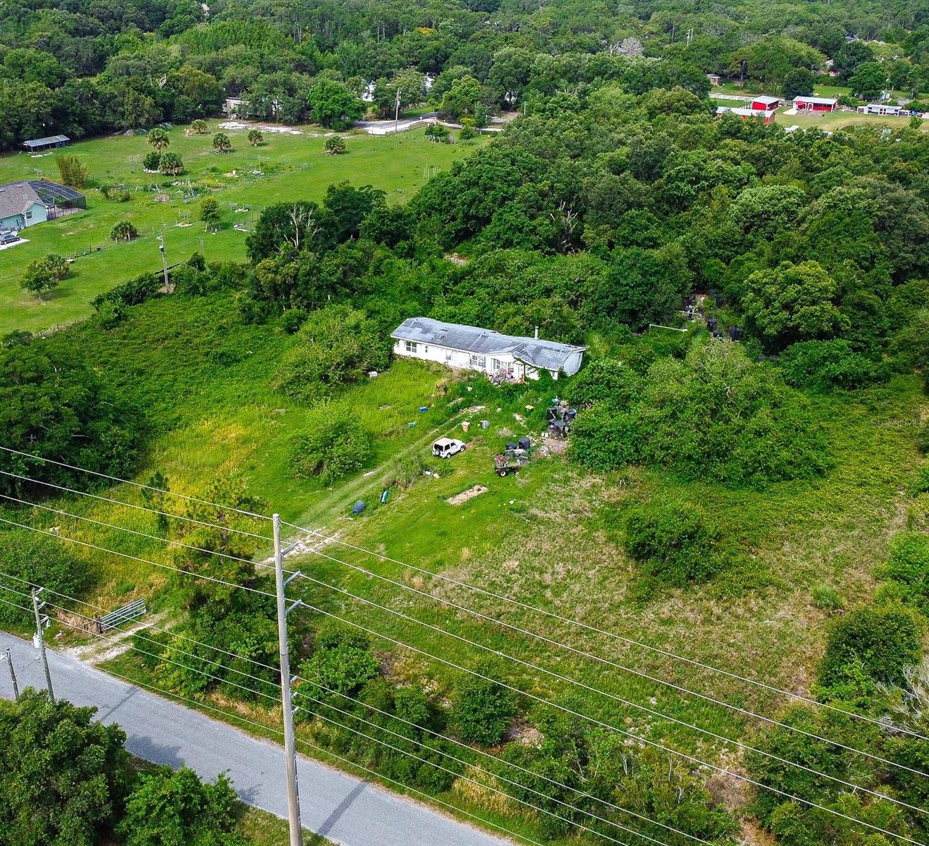 5.47 ACRES TO BUILD YOUR DREAM HOME OR PERFECT INVESTMENT FOR DEVELOPMENT! A great investment opportunity for developers and builders! Here is your great chance to own this land that is high and dry in Saint Cloud! If you are looking for land to build on and develop here in Osceola County, then you found the right property! The VALUE IS IN THE LAND ONLY. This property boasts five and a half acres of land, that has future zoning for low density residential development. The future use of this land will allow three to eight homes for each acre according to Osceola County Zoning. All information is deemed accurate and provided from public records. Room measurements are estimated. Do not approach the property without a licensed real estate agent as appointments are required. The letter from the county and the code is available upon request. The property is only 15 minutes to Downtown Saint Cloud, 30 minutes to the Orlando International Airport, and 1 hour to Melbourne beaches! We have a reasonable reach of the local toll roads for traveling to work or other needs as the 417 is approximately 25 minutes away off of Narcoossee Road and the Florida's Turnpike is off of hwy 192 heading west through Saint Cloud which we can reach in about 30 minutes! Don't forget Orlando's theme parks too! This location offers so much for homeowners and the developer who plans to invest in it. Now is your chance to take part of the rapidly developing East side of Saint Cloud and close to the growing Lake Nona area! Hackney Road is situated off of Narcoossee Road in an area that is surrounded with amazing nature and a peaceful setting. Buyers are to do their due diligence on the intended use and know this is for investment opportunity! Sold AS IS and the mobile home does NOT have added value and is NOT accessible for viewing. Only the land is to be viewed where accessible by appointment only. There are currently two areas of new homes being developed nearby with known home builders; one is at the end of Hackney Road and the other is at the end of Ralph Miller Road.