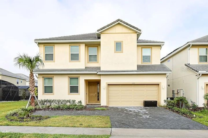 Lake view! Exceptional 12-Bedroom, 11.5-Bathroom Residence in Kissimmee, Fully Furnished! This splendidly appointed 12-bedroom, 11.5-bathroom home in Kissimmee is the epitome of luxury living. The lower level boasts a capacious 2-car garage, an expansive open-concept kitchen featuring exquisite quartz countertops, high-end cabinetry, and top-of-the-line stainless-steel appliances. The kitchen seamlessly transitions into a family room, offering scenic views of the lanai and pool deck. Step outside to indulge in relaxation by the spacious pool or luxuriate in the spa. The first floor also showcases four bedrooms, including a sumptuous master suite, two junior suites, and a fourth bedroom with direct access to a full bathroom. A well-placed laundry room adds to the convenience. For a serene retreat, explore one of the eight upstairs bedrooms, perfect for relaxation or a peaceful nap. The upstairs bedrooms encompass a second master suite, five junior suites, and two additional bedrooms that share the final full bathroom, which is also accessible from the loft area. But that's not all! You may find it hard to leave the resort-like community, which boasts a 24-hour guarded gate, a luxurious clubhouse, an expansive pool area complete with cabanas and a hot tub, a well-equipped fitness center, a playground, sand volleyball and basketball courts, a game room, and even a movie room. Don't miss this incredible opportunity – schedule your viewing today and immerse yourself in the ultimate in luxury living!