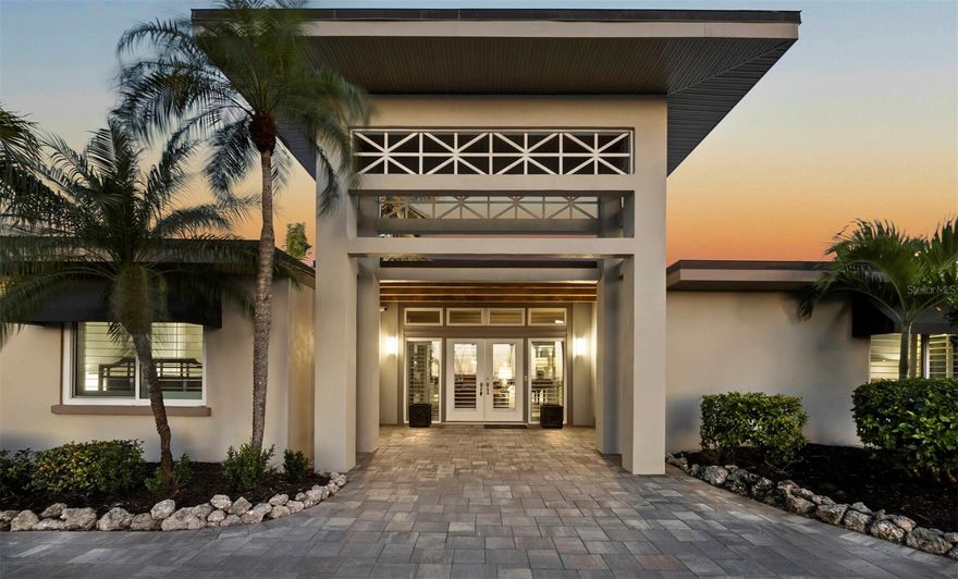 An idyllic island getaway in a coveted Lido Shores location with unobstructed Gulf views and nearby access to the residents-only private beach, this chic contemporary home offers a spacious open layout and excellent indoor-outdoor flow with the convenience of single-level living. With the feel of a private resort, the home boasts thoughtful design features that are both elevated and relaxed, from the dramatic covered double-door entrance to the wood-beamed ceiling in the living room, wide plank floors throughout, louvered window coverings, and walls of glass that showcase exotic foliage. Meticulously renovated in 2025, nearly 3,000 square feet of brightly lit interior space opens seamlessly to a fully enclosed rear terrace with a pool, creating an open-air extension of the living space while preserving privacy. Glass doors and oversized windows showcase a connection to the tropical landscape at every angle. The front living room, with warm-toned wood accents and a cozy electric fireplace, enjoys sight lines to the rear terrace and pool on one side and through the glass front doors to the beach on the other side. Past the front living room, a linear kitchen provides plentiful counter and storage space, with premium stainless-steel appliances and counter seating adjacent to the central spacious dining area. Opposite the kitchen, a second living room overlooks the pool through a full wall of sliding glass doors, and beyond it, yet more shared living space extends the terrace access and offers flex space as a game room, media den, and more. Poised for full-time or seasonal living, this home is an exceptional opportunity to acquire a family vacation retreat or investment property where the sense of chic island comfort cannot be overstated. Lido Shores is enviably located between the bustling hub of St. Armands Circle and the southern end of Longboat Key, with ready access to the Longboat Key Club, shopping, dining, and the cosmopolitan amenities of Downtown Sarasota. Beyond its natural beauty, this island enclave is renowned for its concentration of mid-century and modern homes from acclaimed architects including Paul Rudolph and Ralph Twitchell. Residents of Lido Shores enjoy exclusive access to a private beach through a secure gate, with a covered pavilion for entertaining and resident-only events that strengthen the close-knit nature of the community.