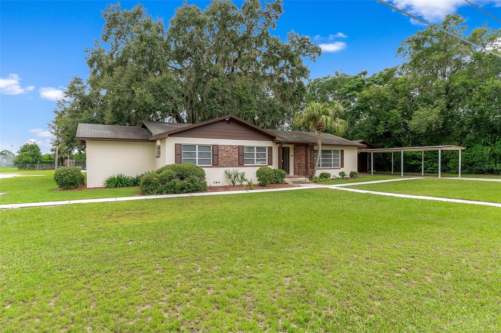Affordable 4 bedroom, 2 bath home in Leesburg with plenty of space inside and out. This property features large living and family rooms, an eat-in kitchen with abundant cabinetry, and a utility area. The master suite offers a tiled bath with walk-in shower, and the second bath is tiled with a tub/shower combo. Additional living space includes a 23x10 enclosed porch, plus a 20x16 one-car garage with two storage rooms and an attached 29x11 carport. The nicely treed lot also includes an 8x6 storage shed. With its flexible layout, this home could make an excellent home office. Seller is offering $20,000 at closing for upgrades with an acceptable offer.