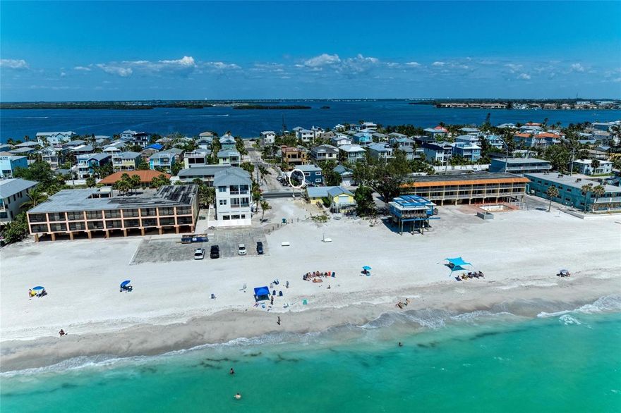 Turnkey beachside investment with a strong, proven rental history and loyal repeat guests—exceptionally positioned and priced to stand out, just steps from the sugar-white sands of the Gulf.
This beautifully updated 2-bedroom, 2-bath condo effortlessly blends coastal charm with income-producing potential in a 4-unit boutique setting. Fully renovated and offered fully furnished, the home showcases a light, airy interior with shiplap and wainscoting accents, durable luxury vinyl plank flooring, and an updated kitchen with newer appliances. A convenient laundry closet with recently replaced washer and dryer adds everyday ease. Two king bedrooms plus a sleeper sofa maximize comfort and guest capacity, while both bathrooms feature quartz countertops and refined designer finishes.

With a consistent history of repeat guests, this property is as enjoyable as it is profitable. Recent upgrades—including a new roof (2024), hurricane impact windows (2025), updated plumbing (2022), and A/C and water heater (2021)—provide lasting value and added peace of mind.

Begin your mornings with coffee and a sea breeze from your front porch, spend afternoons poolside or on the beach just across the street, and unwind with unforgettable Gulf sunsets. With dining, shops, parks, and the island trolley all nearby, every day feels effortlessly like a getaway.

Whether you're seeking a high-performing investment, a personal retreat, or both, this is island living at its finest.