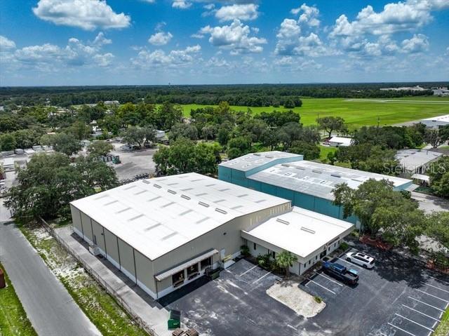 Well maintained 16,550 useable sq ft warehouse (17440 under roof) located along the Central Florida I-4 corridor in Plant City near the airport and across from the US National Guard. Situated on a 1-acre fenced and gated property, the site is zoned M-AP (Airport Light Industrial). Total square footage includes approximately 2150 square feet of air conditioned office space with six offices and reception area, kitchen, two bathrooms, plenty of storage area. The property is well equipped to accommodate shipping delivery with a total of four roll up bay doors (a 3 dock-high doors within a truck well & 1 grade level loading door), outdoor storage/laydown area, and 19 paved parking spaces. Property was recently vacated in preparation for sale.