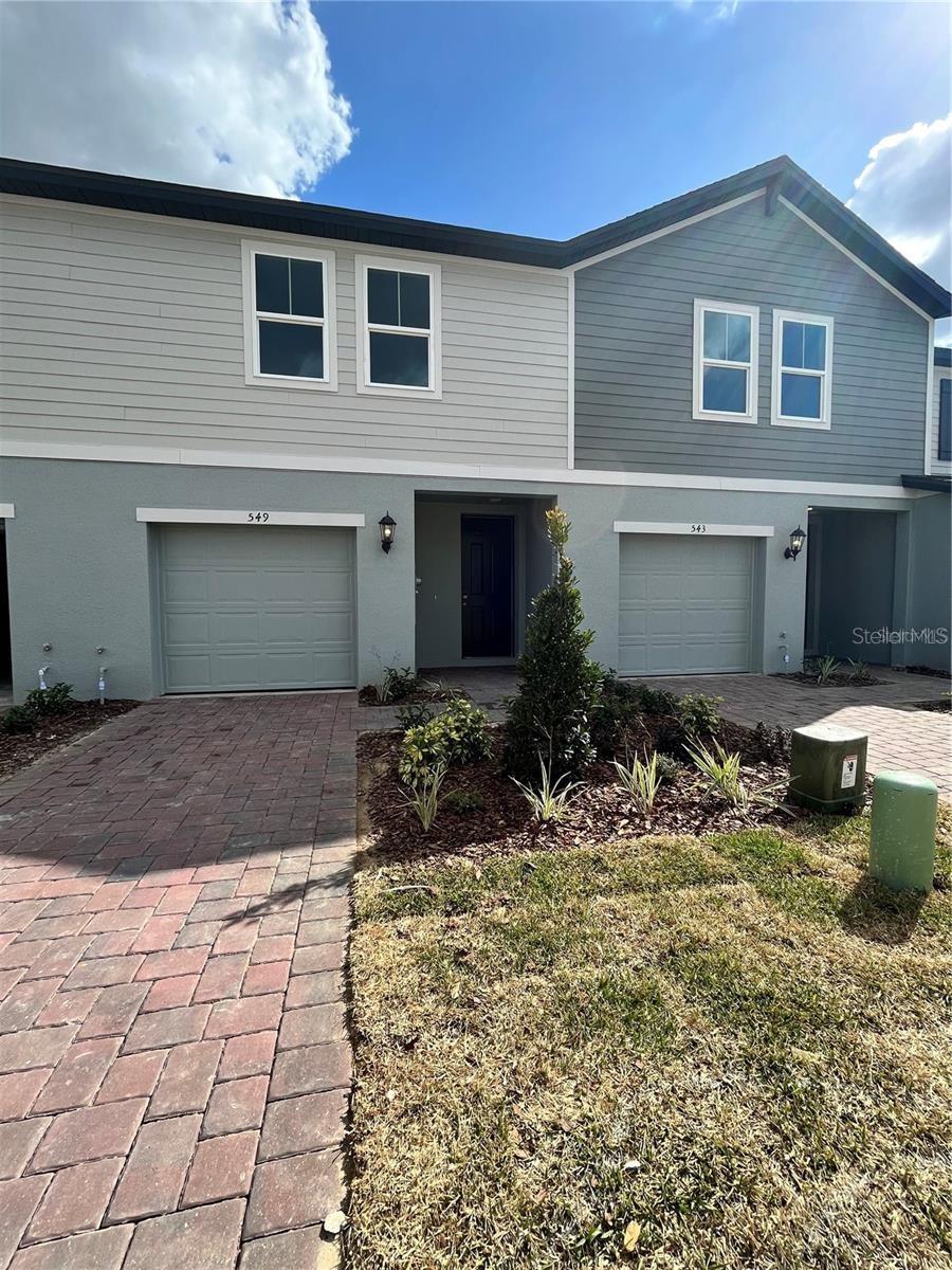 MOVE IN READY - ONE CAR GARAGE townhome with paved driveway in the Championsgate corridor near I-4. The townhome is beautifully appointed with Simply White quartz countertops in kitchen and baths, white shaker cabinets with nickel pulls and tiled throughout the first floor. Community features tot lot. Conveniently located near retail, restaurants, I-4 and Disney.