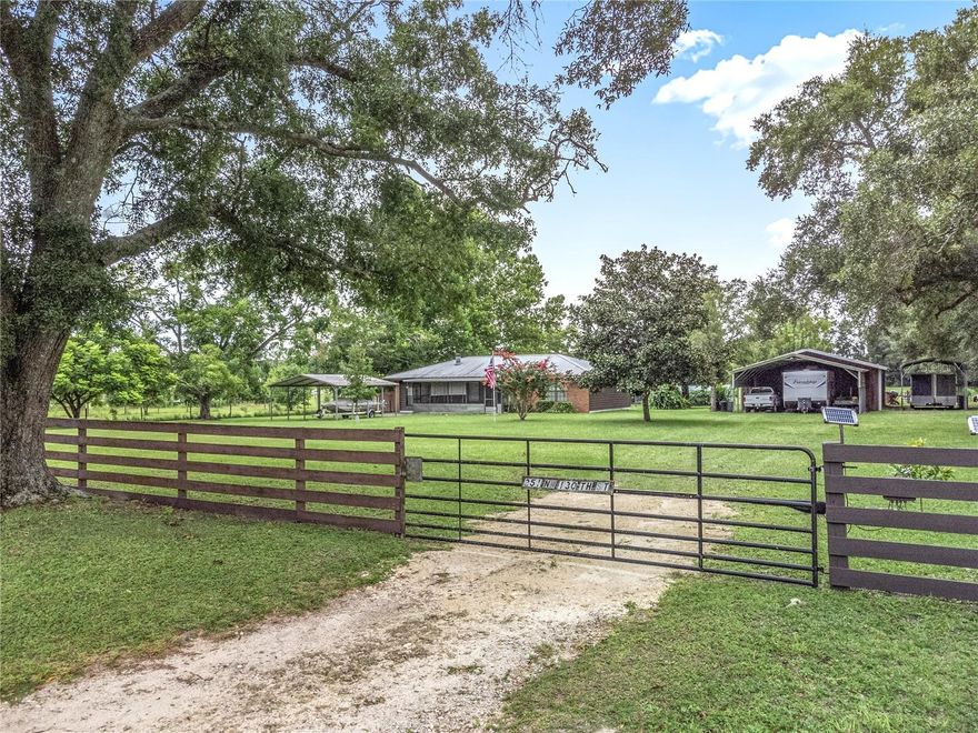 Welcome to this charming 2-bedroom, 1-bath home in the heart of Trenton, Florida. This well-maintained residence features a brand new AC system with a 10-year warranty for peace of mind. Enjoy the inviting screened-in front porch, perfect for relaxing, or step into the bright Florida room at the back of the home. Inside, the cozy living room offers a beautiful brick fireplace, creating a warm and welcoming atmosphere. The property boasts an impressive array of outbuildings and amenities, including a 30x50 enclosed garage with its own bathroom, a 24x28 attached carport, a dedicated RV carport, and an additional 20x20 carport for extra parking. There’s also a greenhouse, chicken coop with irrigation, a 16x36 tractor wood barn, and a 24x24 garden shed with water and an almost finished den—ideal for hobbies or extra storage. Set on a fenced and cross-fenced lot, this home offers plenty of space for gardening, animals, and outdoor enjoyment. Blueberries, mulberries, and blackberries grow right on the property, adding a touch of homestead charm. Whether you’re looking for a peaceful retreat or a functional small farm setup, this Trenton gem offers it all.