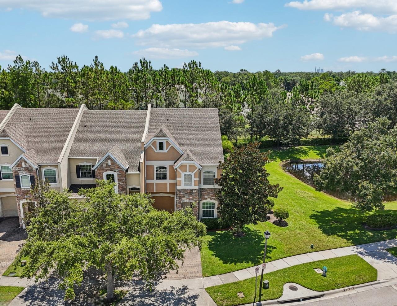 One or more photo(s) has been virtually staged. This property QUALIFIES FOR A CREDIT UP TO $5850 through the seller's preferred lender / Seller may consider buyer concessions if made in an offer ****Luxury upgrades perfectly wrapped in a bow of low maintenance townhome living! Welcome to the Villas at Cypress Springs, where this beautiful END-UNIT townhome combines a spacious floor plan with ease of living and tranquil POND VIEWS. With key updates already done – a NEW ROOF (2023), A/C (2021), and plush new carpeting (2023) in the bedrooms – you can move right in and enjoy. A bright, open layout awaits you inside anchored by a dramatic TWO-STORY LIVING ROOM filled with NATURAL LIGHT thanks to the extra windows only an en-unit can offer. 10’ ceilings on the main floor add a sense of volume, while crown molding, designer paint and upgraded finishes throughout give a polished, timeless feel. The thoughtfully designed floor plan offers two separate living spaces, a dining room off the kitchen, and a SCREENED LANAI accessed through French doors that overlooks the pond – a private space to relax and unwind! Perfectly situated in the heart of the home, the kitchen delivers in both form and function. Featuring GRANITE COUNTERTOPS, a SUBWAY TILE BACKSPLASH, desirable STAINLESS STEEL APPLIANCES (the fridge and stove NEW IN 2024), and a 42” mahogany cabinet package topped with crown molding, it is built to impress! The large island with breakfast bar is a rare bonus in this community, providing extra seating, prep space, and connectivity to the adjacent living area. You will find all of the bedrooms upstairs, including a generous PRIMARY SUITE that becomes a true retreat with DUAL CLOSETS and a well appointed en-suite bath boasting DUAL/SPLIT VANITIES, a large SOAKING TUB, and walk-in tiled shower – classic Toll Brothers luxury! The private enclosed loft flexes easily as a fourth bedroom, home office, play space or even a spacious dressing area with storage already in place. Bedrooms two and three are on the opposite side of the home and all three rooms share a second full bath. The laundry room is also conveniently located on the second floor. Additional highlights include a 1-car garage with a 2-car driveway, easy care CERAMIC TILE FLOORS in all main living areas, multiple STORAGE OPTIONS (pantry, under-stair closet, two linen closets), and decorator touches throughout. The villas community gives residents of the small enclave their own pool tucked away at the end of the cul-de-sac; plus access to a second pool, tennis courts, pavilion, and playground as part of the larger Cypress Springs neighborhood. Bonus – “A” rated Cypress Springs Elementary is just around the corner, ideal for convenience and peace of mind. Located in sought after East Orlando, you are just minutes from SR 417, 407, Lake Underhill and Curry Ford Rd, with easy access to Downtown Orlando, Waterford Lakes, Lake Nona, and the Orlando International Airport. Shopping, dining, trails, and parks are all nearby, and area beaches and theme parks are within easy reach. This is more than a townhome – it is a lifestyle upgrade with space, style and unbeatable surroundings!