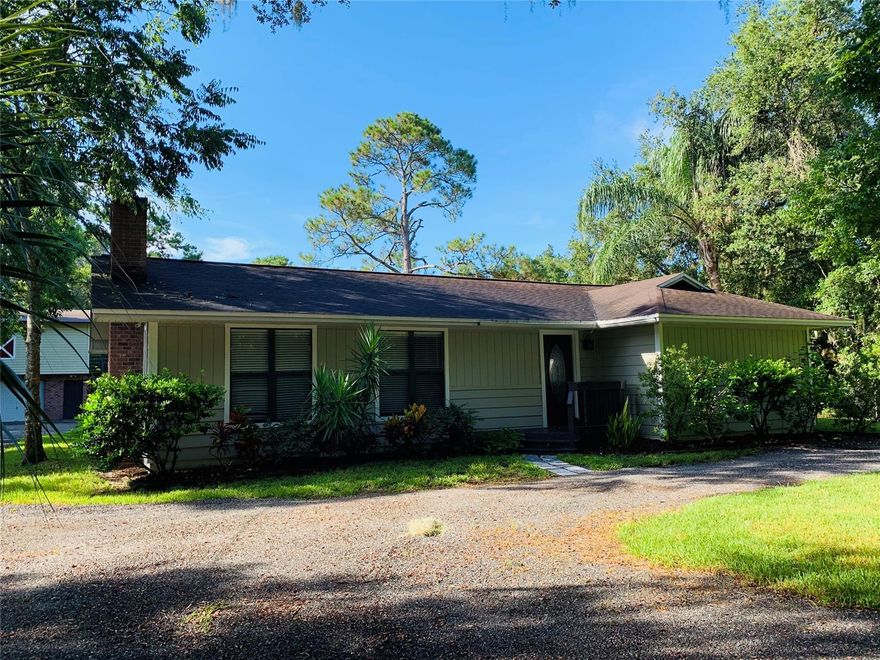 Beautiful 2 acre semi-wooded lot in Central NSB, This lovely home has a tiled foyer that leads to a large living room with a stone fireplace and large floor to ceiling windows. This home features a master bedroom with large walk in closest and a master bathroom with tile shower and a double sink. Second bedroom is large, also with a walk in closet. There are many linen/coat closets through out for plenty of storage. The kitchen is very spacious with Corian countertops, garbage disposal, stainless steel appliances (refrigerator doesn't convey) breakfast bar and pantry. Dining area opens to kitchen and has French doors to 12x32' porch that overlooks beautiful yard. Master bath, guest bath, kitchen and flooring have been recently remodeled/upgraded. The detached 2 car garage offers a 650 sq. ft. apartment on the second floor potential rental income of $600+. Apartment is 1bedroom, 1 bath, full kitchen and laundry hook up in the garage. Air-conditioning in both house and apartment are aprox. less than 4 years old. There is plenty of storage area behind the garage for lawn equipment. Plus there is a shed in the back of the property that can house toys, tools or gardening supplies. Fenced yard is great for animals. Roof was replaced in 2008. Measurements are aprox. Don't miss out on this rare find with no HOA in NSB! ;Water: City