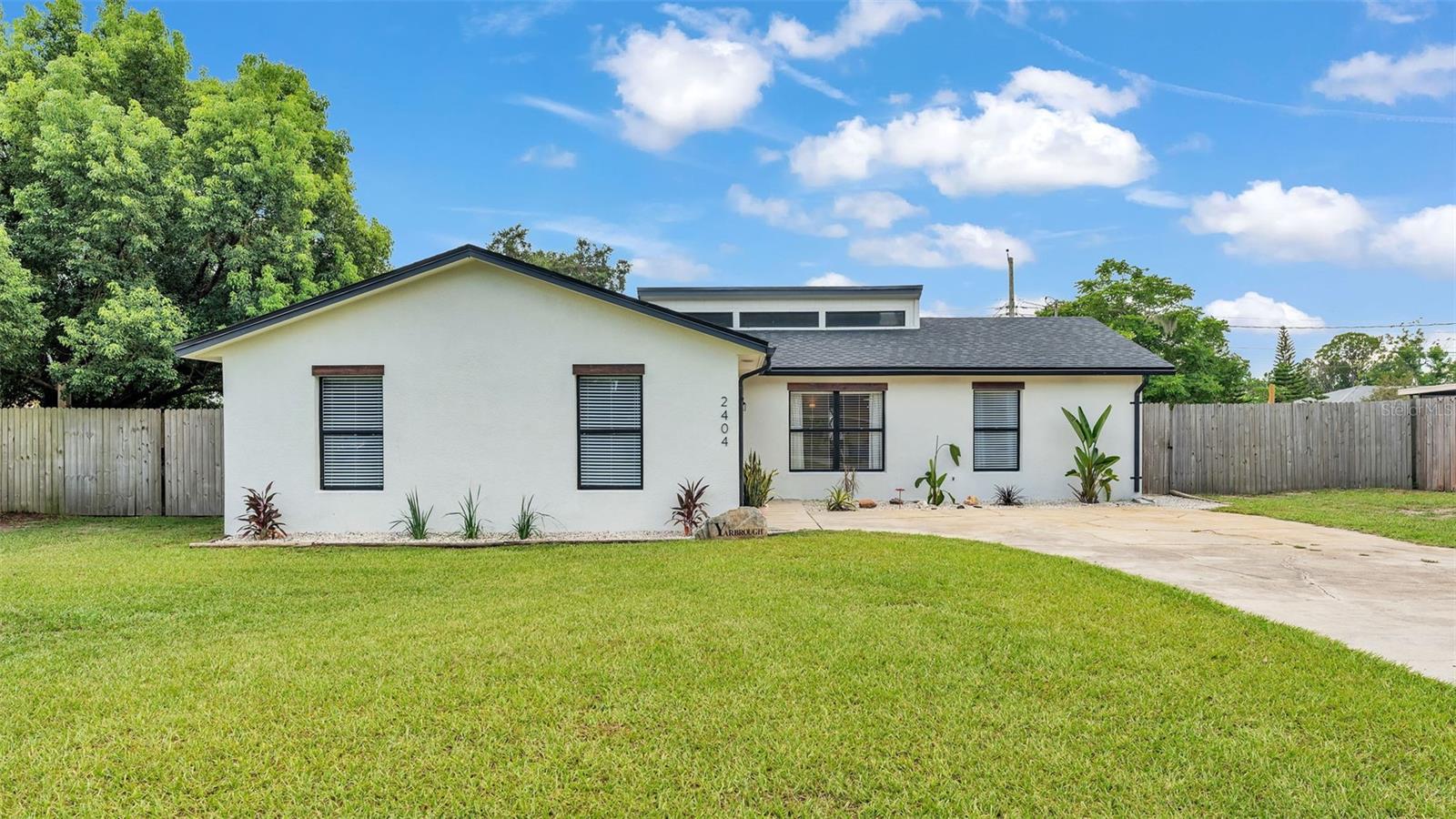 Presenting this charming, move-in ready North Lakeland 3 bedroom, 2 bathroom home with brand new roof (2025) and large bonus room… tucked away on over ¼ of an acre with NO HOA! You won’t find another property on the market with so many features and in such a great location, but at such an affordable price! As soon as you arrive to 2404 View Way (near 98 North and Duff Road), you’ll notice the clean and inviting modern aesthetic with fresh paint & new landscaping. As you head inside, notice the sun-soaked living room, which is perfect for entertaining and leads right into the “heart of the home” - the kitchen! This beautiful space stands out with a custom dining bench and wood table (which stays with the home), a window overlooking the backyard, Kraftmaid all wood cabinetry, new matte black hardware and plumbing fixtures, tiled backsplash, open shelving, updated appliances, pantry closet and easy-to-clean Corian (acrylic) counter tops with an integrated kitchen sink! The primary bedroom has an en-suite bath with tiled shower and a large walk-in closet. The other two bedrooms are located near the guest bath, just off the living room. The bonus room is located at the front of the home and is currently being used as a 4th bedroom. It contains the laundry room and could easily be utilized as an additional family room, office, workout room, or crafting space. Every room features blinds, new light fixtures and fresh paint. Plus there’s brand new carpet with extra lush padding in the bedrooms and tile throughout the rest of the home. Out back in the huge, fully-fenced-in yard, you’ll find plenty of outdoor living space with a vinyl Florida room, fire pit, custom tree house (which stays with the home) and storage area. There are even fruit producing trees (mango and peach). This property is in an established area and provides quick access to restaurants, shopping, medical facilities, parks and Central Florida attractions. Call today to schedule your tour of this special home!