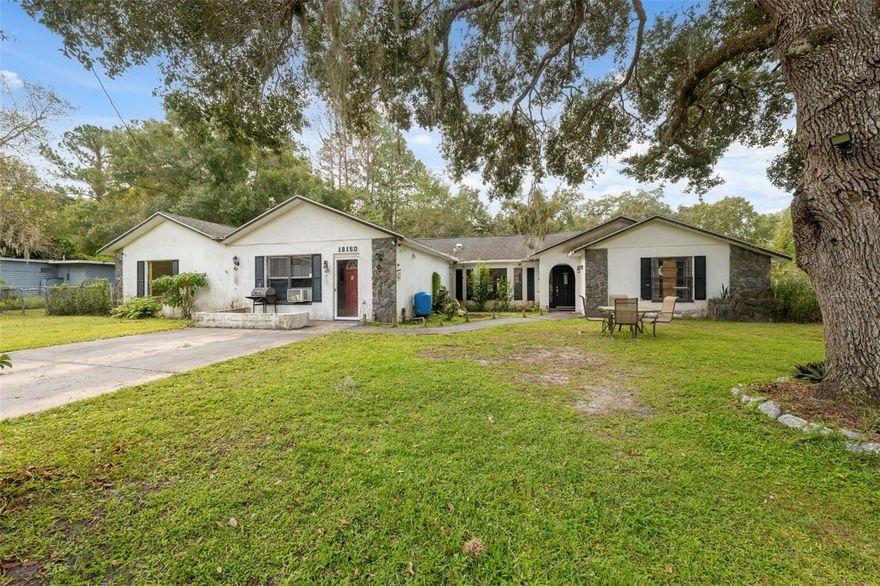 This 6-bedroom, 2-bath fixer-upper is full of potential! The main home offers 4 bedrooms and 1 bath, while the guest suite adds another 2 bedrooms and 1 bath. 

Inside the main home, you’ll find high ceilings, an open floor plan, and a split-bedroom layout for added privacy. The kitchen includes a cozy eating area, and there’s also a separate dining room for larger gatherings. The split layout places two bedrooms on each side of the home, offering space and privacy. 

When you step out to the screened back porch, you’ll overlook a fully fenced yard and an above-ground pool, which is the perfect place to relax or entertain. The mature trees add charm and a laid-back vibe, enhancing the beauty of the property and the roof was replaced in 2016, giving you one less major update to worry about.

Moving on to the attached guest suite, this 2/1 space offers two private entrances and a spacious open living area. The guest suite includes its own private bath, which connects directly to one of the bedrooms for added convenience. While the guest suite currently has access to the main home, it can easily be blocked off to create two completely separate and private living areas. This property truly checks all the boxes. Whether you're looking for a forever home or an investment opportunity, the potential is there to make it something incredible! As an added bonus, there are no HOA or CDD fees to worry about!