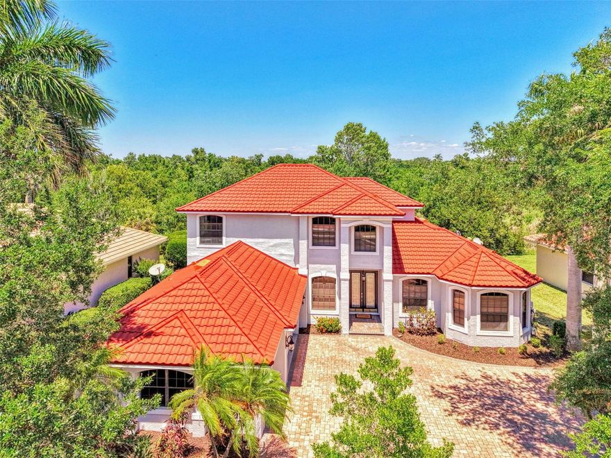 One or more photo(s) has been virtually staged.  Welcome to Three Oaks—where refined living meets natural serenity.  This exceptional 4-bedroom + den, 3.5-bath home with a 3-car garage is perfectly positioned along a 125-acre private preserve and lake, offering rare privacy and breathtaking, unobstructed views—truly a bird-watcher’s paradise.  Step through elegant double glass entry doors into a home defined by timeless architectural details, including graceful arches, tray ceilings, crown molding, and custom niches—features rarely found at this price point. Soaring ceilings, rich bamboo and plank wood flooring, and expansive windows fill the home with warmth and natural light.  The thoughtfully designed layout offers a first-floor primary suite and den for convenient single-level living. At the heart of the home, the gourmet kitchen features granite countertops, custom wood cabinetry, and ample space for both casual dining and entertaining.  Step outside to your private retreat. The screened lanai boasts a sparkling pool and spa, and peaceful preserve and lake views—perfect for relaxing evenings or hosting guests in complete privacy.
Recent updates provide peace of mind, including a new roof (April 2026), fresh interior and exterior paint, new second-floor flooring, a new pool pump (2026), lanai hurricane shutters, and a brand-new portable grill.  Ideally located near top-rated schools, premier shopping and dining, and the world-renowned beaches of Sarasota, this home offers the perfect balance of luxury, comfort, and location.  Schedule your private showing today and experience the best of Three Oaks living.