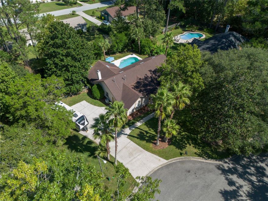 Tucked at the end of a quiet cul-de-sac in NW Gainesville's Hills of Santa Fe, this beautiful 3-bedroom, 2-bath home invites you to enjoy your own private backyard oasis—complete with a sparkling pool featuring a brand-new salt cell, filter and vacuum, a covered porch, and plenty of room to relax or entertain. Sitting on a fully fenced 0.43-acre lot, the property offers both privacy and space, with a separate fenced area perfect for pets or a garden, an extra-wide driveway ideal for parking boats or an RV, and a back gate for easy access.

Inside, you’ll find an inviting floor plan with hardwood floors, vaulted ceilings, and multiple living areas that flow easily for entertaining. The upgraded kitchen features a gas stove, new countertops and cabinets, stainless steel appliances, and a charming pool view right above the sink. The living room, anchored by a cozy fireplace, is perfect for relaxing or gathering with friends, while the formal dining room features French doors that open onto the patio and pool area for effortless indoor-outdoor living.

The primary suite includes a remodeled bath with a large tub, separate shower, and new vanity, along with a bonus room on the north side overlooking the pool—perfect for a home office, nursery, workout room, or reading nook. The split floor plan provides privacy for the guest bedrooms, and the guest bath opens directly to the pool for convenience.


Additional highlights include a 2-car side-entry garage with attic storage, a covered front entry, and a 2013 roof. With no HOA, a peaceful cul-de-sac location, and an easy, open layout designed for both comfort and entertaining, this home is a rare find that truly has it all!
