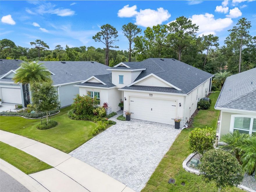 Discover your dream home and exquisite lifestyle in the highly sought after Lakes of Mount Dora community. Recently constructed in 2023, this custom built property features exceptional upgrades and designer enhancements. A entertainer's dream that offers water views in front, a private tree-lined yard in back, and upgrades throughout, including stunning porcelain tile floors that flow seamlessly through the home. The chef's kitchen, dry bar, and luxurious primary suite with two walk-in closets and an oversized double shower will wow you. Be careful -- your guests may never want to leave! The community itself is truly second to none, centered around an impressive 18,000 sq. ft. clubhouse offering something for everyone. Inside, you'll find a card room, library, billiards room, craft room, fitness center, and a spacious social hall that hosts a variety of entertainment and events. Step outside to enjoy the resort-style pool, cozy fire pit - perfect for winter evenings and s'mores - and a wide array of sports amenities including tennis, pickleball, croquet, bocce ball, a softball field, and even cornhole. Residents also enjoy private golf cart access to the Country Club of Mount Dora where you can lunch or dine at the restaurant or take on the challenge of its beautifully maintained golf course. A future boat ramp will provide access for residents to launch their gas-powered boats onto scenic Loch Leven Lake. For added convenience your $280 monthly HOA fee also includes secured, fenced storage for boats and RVs. Furthermore, within 10 minutes you can be strolling through historic Mount Dora, enjoying its renowned restaurants, charming boutiques, and unforgettable small-town character. The lifestyle here leaves little to be desired!