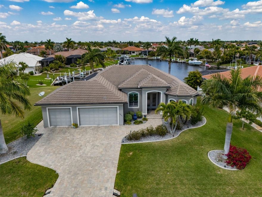 Burnt Store Isles! Exceptional custom-built 4 bedroom, 2 bath, 3-car garage waterfront pool home with sailboat access to Charlotte Harbor leading to the Gulf! 70' of waterfrontage on deep wide turning basin featuring extended concrete dock with water and electric plus 10,000 lb. boat lift. Built in 2018 to include an open floor plan, high end finishes, zero-corner slider seamlessly blending inside and outside living, built-in entertainment center with electric fireplace and wood flooring throughout. Nestled on a quiet street in a popular golf and boating community, this home is just minutes from the Yacht Club, Fishermen's Village, and the historic downtown area of Punta Gorda. Enjoy access to arts, community events, entertainment, world-class fishing, boating, fine dining, and beautiful parks. Don't miss the chance to make this home your new Florida retreat or permanent residence! Schedule your private showing today!
