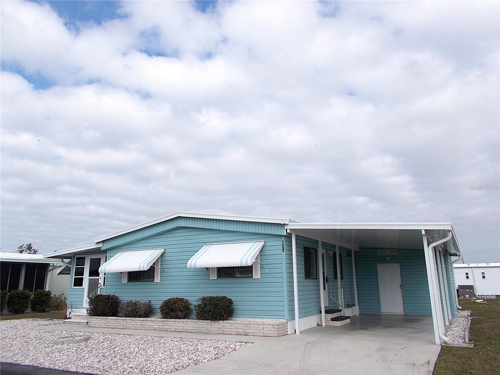 This is it!! Fabulous & clean 2 bedroom, 2 bath furnished mobile home awaits it's new residents. Brand new hot water heater, new flooring in the bedrooms, living room, hallway & primary bathroom, new back door in shed and a brand new carport, facia & gutters (thank you Milton!). Sandalwood Park is perfect for the seasonal visitor and year round residents alike. It's pet friendly (size, breed & weight restrictions) and has a back gate entrance/exit for use by residents which allows for easy access to grocery stores, medical facilities and much more. Low quarterly fees and tons of activities are found here, including the heated pool, shuffleboard courts, card nights, trivia night, bingo, seasonal concerts, potluck dinners, picnics and so much more! There's a reason why Sandalwood Park is so sought after. Come take a look at this great home today and enjoy the fabulous lifestyle found here in Sandalwood Park!