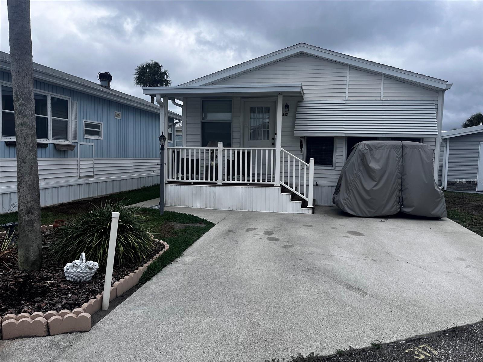 Great opportunity to own a double-wide all one level home in the sought-after ORO community! This charming 2 bedroom, 1.5-bath home is filled with natural light thanks to two skylights and lots of windows.You will find four ceiling fans throughout. The roof was replaced just last year, and the home offers plenty of built-in closets for extra storage. Furniture is included, making this an easy and comfortable transition for seasonal or full-time living. Relax and unwind on your covered front porch- perfect for enjoying those breezy Florida days. Best of all, in ORO you OWN THE LAND, and the HOA covers: trash, water, basic cable, sewer, lawn care, 24-hr security & resort-style amenities like two heated pools, 9-hole golf, tennis & pickleball courts, and access to Lake Davenport for boating and fishing. Make sure not to miss this opportunity!