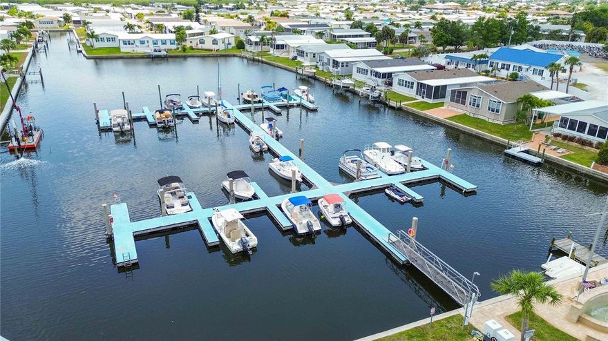 Welcome to Windmill Village in Punta Gorda! Resident-owned 55+ GATED community | TWO ON-SITE MARINAS with plenty of FIRST-COME, FIRST-SERVE boat slips with GULF ACCESS | ON-SITE BOAT RAMP | BOAT TRAILER PARKING/STORAGE | TURN-KEY FURNISHED | HEATED POOL | LARGE SCREENED LANAI | ATTACHED GOLF CART GARAGE/WORKSHOP | LOW $260/month HOA (includes landscaping, water, and sewer) | $18,285 "buy-in" (refundable upon resale) WITH SELLER OFFERING a $9,000 credit toward new owner’s buy-in cost — Windmill Village is where coastal living meets convenience and community. This beautifully maintained, fully furnished Jacobsen home offers 3 bedrooms, 2 bathrooms, and OVER 1,500 square feet of thoughtfully designed living space on a desirable corner lot. Bright and airy with abundant natural light, the home features an open SPLIT FLOOR PLAN, HIGH CEILINGS, and energy-efficient 5-zone Mitsubishi mini split systems for personalized comfort throughout. The kitchen is both functional and stylish with granite countertops, stainless steel appliances, a center island with breakfast bar, and ample wood cabinetry with crown molding. The spacious living area is enhanced by large double-pane windows and a seamless flow into the dining space. A versatile den with French doors can easily serve as a home office or third bedroom. The primary suite offers generous closet space, dual vanities, and a beautifully updated walk-in shower with skylight, while the guest bedroom includes a walk-in closet and access to a full bath. Step outside to your LARGE SCREENED (14x17 ft) LANAI—perfect for relaxing or entertaining—along with a paver patio and COVERED CARPORT. This is ideal for those who love to be on the water and be near downtown Punta Gorda Isles, where there are great restaurants and plenty of events going on. Additional community features include a post office, beautifully maintained grounds, and an upscale community center designed for social gatherings and events. This is a rare opportunity to own a move-in-ready home in one of Punta Gorda’s most desirable waterfront communities.
