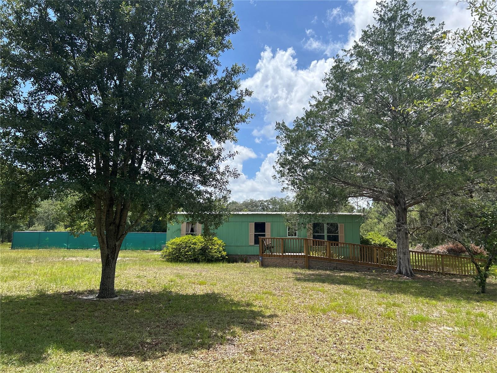 QUIET COUNTRY LIVING WITH MODERN UPDATES!
Welcome home to peace and privacy on this beautifully updated 2 Bedroom, 1 Bath double wide mobile home situated on 3.31 acres with paved road frontage. Completely remodeled from top to bottom, this home features brand new wood cabinetry, all new flooring, textured drywall throughout, and a brand new HVAC system for year-round comfort.
Step outside and enjoy your very own fenced in-ground swimming pool—perfect for those warm Florida days—complete with a cookout area ideal for entertaining. A powered and plumbed storage shed adds even more functionality to the property.
Located just a short drive from Ocala, Dunnellon, and Gainesville, you’ll enjoy the quiet of the country with the convenience of nearby amenities. Come see all this charming country retreat has to offer! Adjacent 3.3 Acres available listing#OM702778.