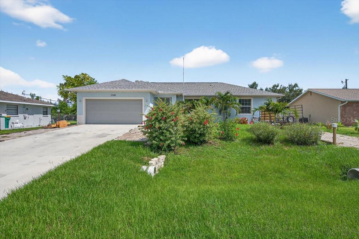 Beautiful, newer-build 3 bedroom/2 bathroom POOL home in East Englewood- NO FLOOD ZONE or HOA! With a split floor plan, covered front porch, paved back patio with a pool cage- all only a few years old! Vaulted ceilings and an open layout give this home a spacious, welcoming feeling. Porcelain tile throughout. Stunning kitchen features Quartz countertops, a 6 foot Island, all stainless-steel appliances and wood, soft-close cabinets and drawers. Roomy master bedroom features a walk-in closet and ensuite with a large stand-in shower and dual sink vanity. Bathroom #2 provides a shower and tub perfectly located between the two secondary bedrooms. Sliding glass doors in the dining area open onto a clean patio with plenty of room for lounging and entertaining before taking a dip in the glistening blue pool. The lush backyard is irrigated with a rain-bird system and includes a newer storage shed. Fantastic location- within minutes of sandy beaches, plenty of shopping, and popular restaurants. Schedule a viewing as soon as possible!