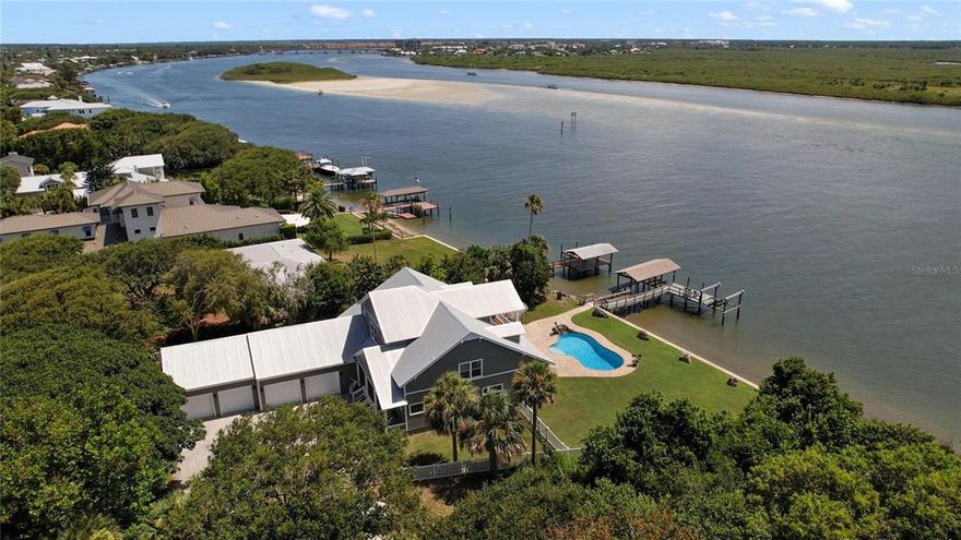 UNPRECEDENTED LOCATION & INCREDIBLE WATER VIEWS! Exclusive North Beach, with 156 feet of ICW RIVER FRONTAGE!!! Coastal Hickson Home (2013) is TRULY ONE OF A KIND! Private Private fenced property on .56 acre, deep front lawn, shaded by irreplaceable Banyan Tree (the OLDEST) on the island. Large Deep Water Boat Dock (NO WAKE Zone) with 2 lifts rated for 4,000 & 7,000 lbs, newer seawall, just minutes to the mouth of Ponce Inlet, Ocean, Ponce Lighthouse and Disappearing Island. EXTRA Deep Saltwater Pool with Sun Ledge, Waterfall Tiki Gazebo, outdoor shower and MASSSIVE back yard!  WHOLE HOUSE GENERATOR (underground propane tank.) Once inside this spectacular property you will enjoy 180 degree views from almost every room. 5 BR, 4 BTHS, open concept floor plan, double hung windows w/ built-in blinds, hand scraped, site finished hardwood floors, 10ft doors. Chef's kitchen with granite, double ovens, stainless steel appliances, pantry and laundry room. Spacious main level owners suite with peaceful, serene views of the river, spa bath, oversized closet with closet system. Upstairs leads to the expansive sunset lounge, with vaulted ceilings and covered deck, perfect for watching those stunning sunsets and boats returning from a day on the water. In addition are the 2 spacious secondary bedrooms with a shared jack n' jill bath, additional 5th bedroom with hall full bath, plus private workout room, spacious closets and plenty of attic storage. CLIMATE CONTROLLED FOUR CAR GARAGE with 2 extra deep bays, 12 foot ceilings, accommodates lifts and YOUR COLLECTION. This waterfront home on the heart of New Smyrna Beach is 1,000 feet to the beach walk-over and ocean, 1.8 miles to New Smyrna Dunes Park (Dog Beach) hidden treasure of North Beach, 1.1 miles to Flagler Ave., fabulous dining & shopping. TAKE ADVANTAGE OF THIS RARE OPPORTUNITY TODAY!!! All information is deemed reliable BUT not guaranteed and should be independently verified.