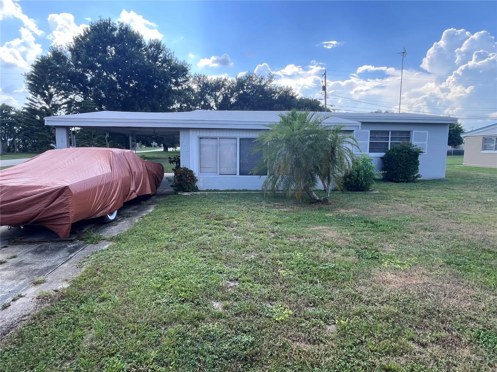 Nestled on a spacious 9,600 sq ft corner lot in the welcoming Sun Ray Homes neighborhood of Frostproof, FL, 262 Walter Ave is a charming 2-bedroom, 1-bath block construction home offering 1,178 sq ft of comfortable living space. Built in 1960 with a solid masonry structure and slab foundation, this home features a bright eat-in kitchen with essential appliances including a dishwasher, refrigerator, and range. The adjacent living room provides a cozy area for relaxation or entertaining, while the two well-sized bedrooms are supported by a full bathroom. The home features durable laminate flooring throughout and central air and heat with ceiling fans to ensure year-round comfort. Additional highlights include indoor laundry and utility room, plus an 8×7 storage closet, an attached single-car carport, and two exterior utility buildings. The large, mostly flat yard is serviced by a well and sprinkler system, perfect for gardening or outdoor activities. Located just off Hwy 27 in a quiet, friendly community known as “The Friendly City". With a strong appreciation in market value, low property taxes, and excellent potential as a primary residence or rental, this property is a fantastic opportunity for first-time buyers, retirees, or investors seeking value, space, and versatility in the heart of Central Florida.
(Corner Lot, New roof in Jan 2024, new interior paint, updated kitchen cabinets, back splash, light fixtures, working hot tub in the back yard, two storage sheds staying with home.)