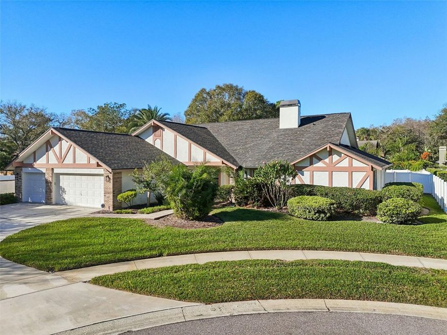 Nestled in the heart of Carrollwood within the exclusive neighborhood of The Hamlet, this stunning 4-bedroom, 3-bathroom home offers over 3,200 square feet of beautifully designed living space—all on one level. Thoughtfully laid out, the split floor plan features the spacious primary suite on one side and three additional large bedrooms on the other, providing both privacy and comfort. Situated on a quiet cul-de-sac just minutes from all the conveniences of Dale Mabry Highway, this home is perfect for both relaxation and entertaining. The expansive custom kitchen is a true showpiece, boasting granite countertops that wrap around the entire space, stainless steel appliances, custom cabinetry lighting, and a pantry with pull-out drawers. From the kitchen, take in serene views of the sparkling swimming pool as you cook or clean up. Use the pass-through window from the kitchen to back patio for easy entertaining.  The outdoor oasis features a screened in paver patio with two ceiling fans, a large swimming pool, and a fenced in grassy backyard.  The inviting family room showcases vaulted ceilings, a cozy fireplace, and a built-in entertainment center, while the formal dining room and versatile bonus room offer endless possibilities for hosting gatherings, creating a game room, or setting up an office. Additional highlights include a large laundry room with extra fridge, a full-house water softener, a NEW ROOF installed in 2024, and a 3-car garage with extended driveway for ample parking. This exceptional property combines modern updates, functional living, and an unbeatable location—making it the perfect place to call home.