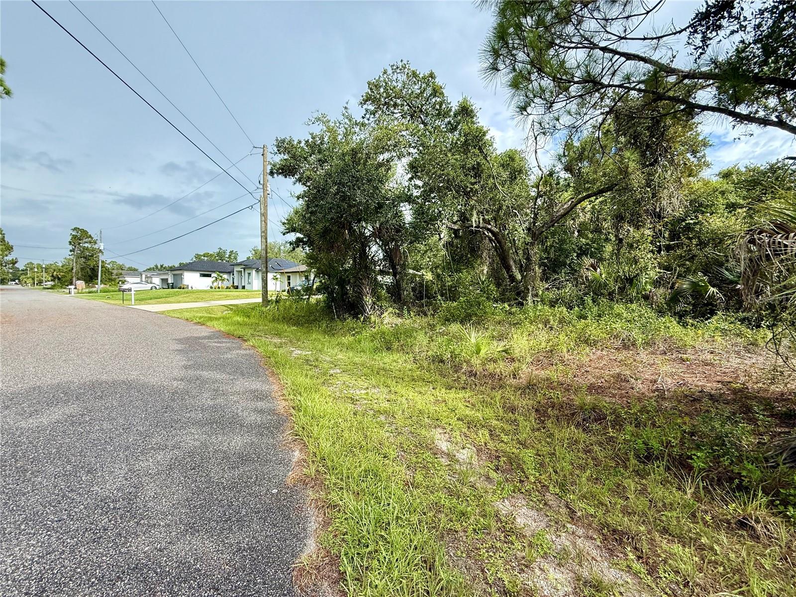 Looking for that perfect piece of land to build your slice of paradise on? Here's a great lot in this up-and-coming area of North Port! NO flood insurance required, save money and build with confidence!!! Electric at site, and no need to worry about mitigating Scrub Jays as property is NOT located in a habitat. Bring all your toys...store your RV, boat, kayaks, put up a detached garage, shed for an art studio, trampoline, or treehouse, doesn't matter as this is a non-deed restricted area of Sarasota County! And of course, what could be more Florida than having your own pool which the property has plenty of room for! Property is close to all amenities including sandy beaches & crystal waters of Venice, Englewood & Boca Grande Beaches, Golf Courses, boat launches, minutes from TWO Spring training Stadiums, the Rays & the Braves who hosts games against the Yankees, Red Sox, Mets & more. Have local builder with floorplans of 3 bedroom 2 bathroom homes with 10’ ceilings, 8’ doors porcelain plank flooring throughout, Quartz/Granite, lighting & fans, appliances, Impact windows…all-inclusive pricing starting at $320,000.