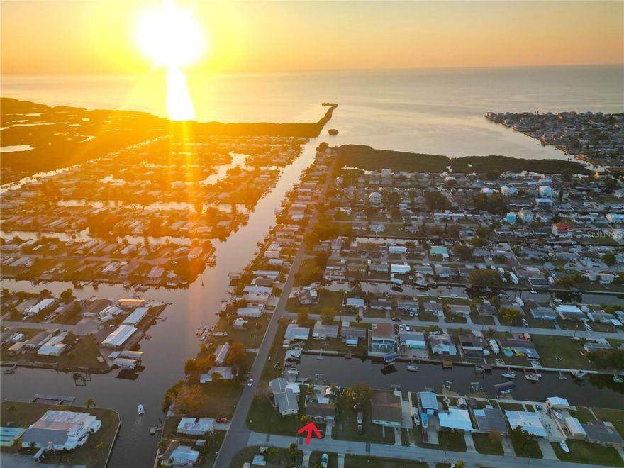 WATERFRONT PARADISE on WIDE DEEP CANAL just a FEW MINUTES out to the OPEN GULF OF AMERICA with BREATHTAKING SUNSETS!  Please see attached virtual tour drone video 1 that gives you the true vision of how close you are to the OPEN GULF so you can start enjoying the SALT LIFE! The CURRENT FLOOD INSURANCE POLICY is TRANSFERABLE to the NEW OWNER which offers SUBSTANTIAL SAVINGS! Come see this unique COASTAL LIFESTYLE and experience your own 8,000 lb. private boat lift and dock with endless water vistas that offer a lifestyle that feels like a permanent vacation! The expansive outdoor living area is perfect for entertaining guests (pls see virtual tour #2 attached) watching the dolphin at play, enjoy the manatee passing by slowly along with all the wild bird life! You will feel so privileged to walk out to your boat lift and take off fishing to catch your own fresh fish, scallops and crab dinner, cruise out to the sand bar for fun in the sun and stop for lunch and/or cocktails at the local waterfront restaurants/bars. 
This unique and very friendly Community with NO HOA also has the option of going out joy riding on your golf cart to nearby events and entertainment while enjoying the beautiful weather. This fully remodeled 2 bedroom, 1 bath, 1 car garage Coastal Gem with screened in Florida Room is full of excitement and meticulously maintained! New elevated AC 2025, Water heater 2022,  Roof 2014 (great condition), all new kitchen appliances and countertops/cabinets 2025, new bathroom vanity and bath tub/tile 2025, new pavers, drainage and seawall cap 2024, all new PGT Hurricane windows w/warranty along with Faux wood window blinds 2025, new doors/frames 2025, Eastern Architectural Hurricane front and back doors 2025, 6 person hot tub 2022, new gray water pump 2022, 8'x7'shed 2020, fresh exterior paint 2020 and tamper resistant electrical outlets 2025. All work performed was completed with permits.
The public boat ramp, 3 Marinas, Hospital, library and shops are just minutes away. There is so much fun to be had at Hudson Beach and restaurants/bars around the corner, SunWest Beach/Park just 10 minutes away and of course the world famous Clearwater Beach is approx. 45 minutes away. I75 & Suncoast Express Parkway are within 30 minutes which makes it convenient to travel to the airports and to Tampa and St. Peterburg to work and/or play by attending the Professional Football games, Hockey, Baseball etc. This is an awesome full time home or seasonal rental. Easy show, come check it out!
