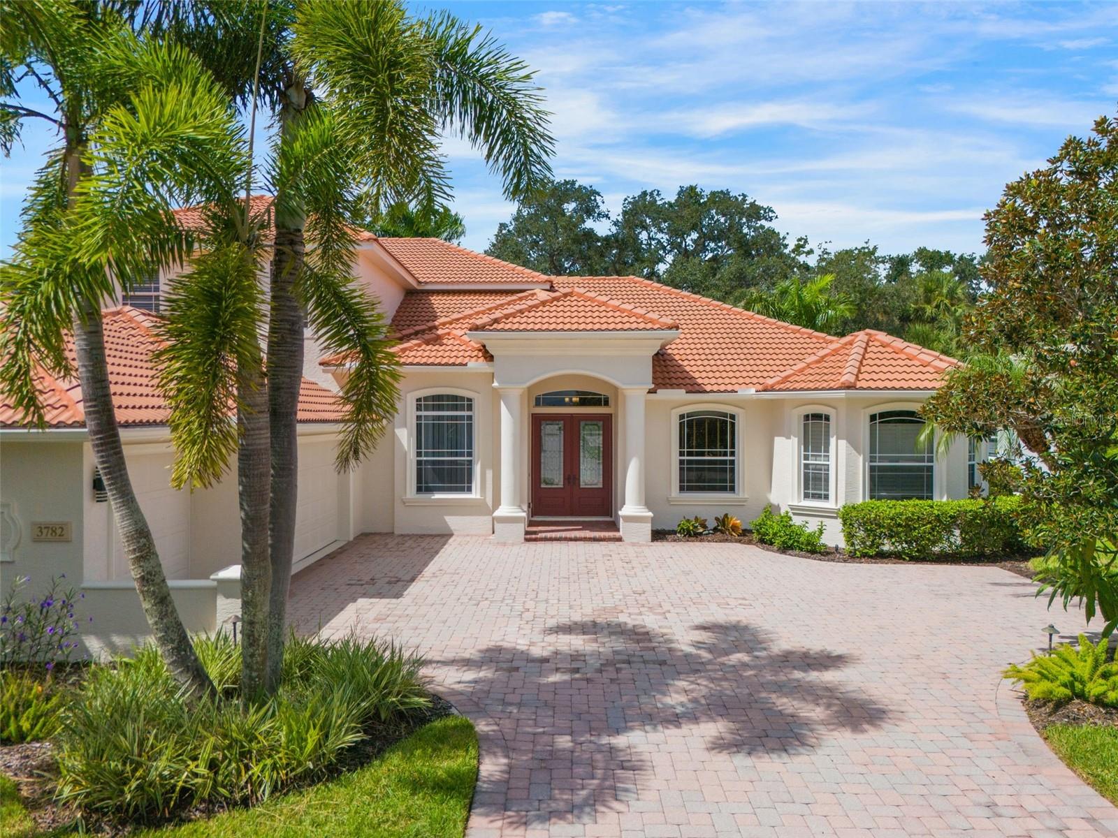 One or more photo(s) has been virtually staged. Fully Renovated Oasis in The Hammocks Sarasota east of I-75 – Custom Closets, Unparallel Space, and Incredible Outdoor Living! Welcome to this exquisitely renovated home in the heart of The Hammocks, where luxury, functionality, and tropical serenity come together. Every inch of this property has been thoughtfully redesigned, offering a lifestyle with high-end finishes and custom upgrades throughout. Step inside to find new and refurbished flooring, including elegant ceramic tile, rich warm wood accents, and luxury vinyl plank in all the right places. The entire home has been freshly painted inside and out. It features modern fixtures that complement the open, airy layout. The oversized bedrooms boast comfort and space rarely found, while the huge master suite includes a custom-designed closet that's a dream for anyone who values storage and style. The kitchen is a showstopper, equipped with top-of-the-line appliances (Viking gas cook top), sleek cabinetry, and a layout made for entertaining. Whether you're cooking for family or hosting guests, you'll love the flow from the kitchen to the living and dining spaces. Separate dining space available and sitting room for conversation. Do you work from home or just need some additional office space? This home has a well-appointed study/den with custom built in cabinets and desk. This home also features unbelievable storage throughout, combining practicality with elevated design. From custom closet systems in three bedrooms to additional storage nooks and cabinetry, you’ll never run out of space. Ever heard of a "Florida Basement"…check it out in this home. Sashay outside to your private tropical paradise. Surrounded by lush, mature foliage, the backyard is a tranquil retreat made for outdoor enjoyment. Fire up the grill, relax under the shade under the oversized covered lanai, or unwind on the private open aired patio. Maybe you might want to sneak upstairs for some privacy and enjoy the upstairs balcony — a perfect spot for morning coffee or evening sunsets. The Hammocks is a nature lovers dream. Lakes, playground, beautiful foliage, greenbelts, winding sidewalks, birds and deer. It is conveniently located to shops, restaurants, Rothenbach Park and several golf courses. Don’t miss your chance to own this stunning retreat in The Hammocks — schedule your private tour today!