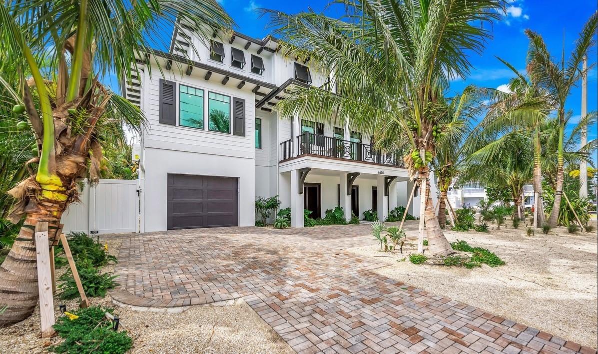 Paradise awaits at this stunning, coastal contemporary home, featuring 9-ensuite bedrooms and 2 half bathrooms. High end coastal
finishes can be seen throughout including custom millwork and designer tilework. A large chef's kitchen features an oversized island and stainless steel appliances, perfect for entertaining a large group. The expansive living area is offset by an outdoor balcony and dining area for large gatherings. The third level of living offers a bonus game room for the young at heart, wet bar and balcony. A full service elevator offers easy access to all levels of living and to the outdoor areas. The home is being sold turn key furnished with everything you need for your beach vacation. The outdoor area is a resort style oasis with oversized pool and jetted spa, and swim up bar, all surrounded by topical landscaping. An expansive lanai offers plenty of space for entertaining as well. The rooftop deck offers panoramic views of the Gulf of Mexico and is perfect for sunset viewing. This is the perfect location, just a few steps to the beach and the island trolley has a stop adjacent to the property. This home is fully elevated and designed specifically for tropical weather. Located in an A1 zone there are no limits as to potential vacation rental income. This property would also make a great family retreat. Truly a one of a kind opportunity to own your piece of paradise! Call today for your personal tour of this magnificent beach retreat!