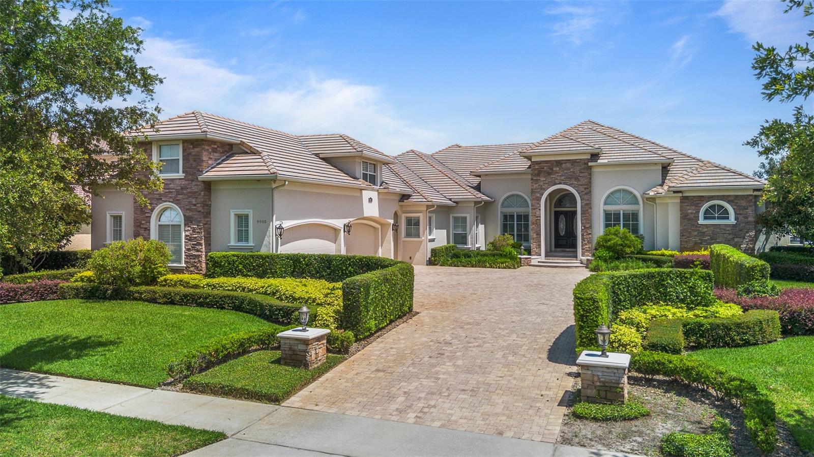 Welcome to a home that isn’t just designed—it’s curated.
Tucked behind the gates of one of Central Florida’s most exclusive golf communities, 9905 Lanai View Court is the kind of estate that makes you pause. Nearly 7,000 square feet of single-level, custom-crafted living plus more than 800 square feet private media room on the second floor. Every detail intentional. Every space elevated.
Set on almost three-quarters of an acre, this Stonebridge-built masterpiece merges classic elegance with the kind of indoor-outdoor living that defines Florida luxury. Think: expansive travertine floors, warm wood textures, and a seamless flow from light-filled interiors to an outdoor oasis made for entertaining.
The heart of the home? A chef’s kitchen worthy of its name—Sub-Zero, Thermador, Electrolux—all the names you expect, plus a breakfast bar for eight that says, this is where weekends begin. Around the corner, a wine cellar, a card/media room, a game room with built-in bar... this house plays just as hard as it lives.
But the showstopper? Step outside.
A custom bird-shaped saltwater pool, sprawling screened-in terrace, and a fully loaded summer kitchen—full-size fridge, grill, range, dishwasher, bar seating—all under cover and designed to entertain year-round. Whether it’s cocktails at sunset or brunch after golf, the vibe is effortless sophistication.
The layout is thoughtful, too: five bedrooms, all on the main level, separated for privacy. The primary suite is its own retreat with a wet bar, built-in workstation, and a spa-like en-suite bath that feels more five-star resort than residential.
With an oversized 4-car garage, a large driveway, and a golf cart bay in the garage, there's planty of space for your toys.
Located in Keenes Pointe, with 24-hour guard-gated security, private access to the Golden Bear Club’s Jack Nicklaus-designed course, and the Butler Chain of Lakes just minutes away, this home offers not only privacy—but prestige.
Downtown Orlando, world-class dining, top private schools, and theme parks are all within easy reach. But when you’re here, you might just forget you’re anywhere near the city.
This isn’t just a home. It’s a statement.
Elegant. Iconic. Effortless.