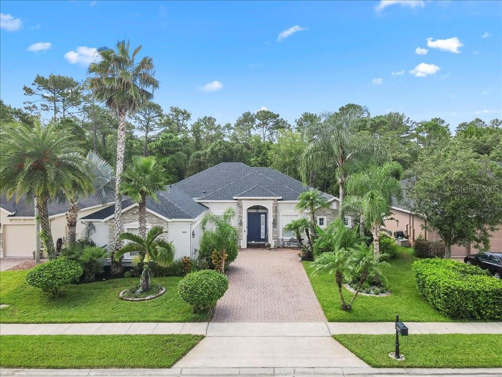 Do you want to live within city limits, close to all amenities and still see wildlife abound? Can you see yourself sitting on your lanai, listening to your pool fountains and watching the butterflies dancing in your backyard?... then look no further! This serene oasis is for you! AMAZING OPPORTUNITY TO OWN A MOVE-IN READY POOL HOME IN OVIEDO’S PREMIER COMMUNITY, THE SANCTUARY! This established community offers top rated Seminole County schools, resort style amenities including clubhouse with a large pool & splash pad, fully equipped gym, volleyball/basketball, a soccer field, playground, & tennis courts; plus, gorgeous conservation sprinkled throughout the community for walking, biking, or running! This stone elevation home is situated on a prime 0.21-acre lot, featuring a cul-de-sac with a pond & wooded conservation area behind the property. The sellers, who are the original owners, have meticulously maintained & updated the home, showcasing their pride of ownership from the moment you arrive. This nearly 2,600 heated square foot home offers a 3-way split floorplan with four spacious bedrooms, three full bathrooms (including a pool access bathroom), a study/office, formal living and dining rooms, and a kitchen/great room area. The courtyard entry garage provides ample brick paver driveway space for parking or recreational activities. The expansive covered porch area (18' by 16') leads to a screened pool with a spa. Both the lanai & pool deck are finished with brick pavers. The pool surface is Pebble-tec with a lifetime warranty. The new pool pump (2024) is energy-efficient with multicycle technology. The fenced-in backyard is perfect for a play set or pets. Recent updates include: Architectural shingle roof (2025) with front & back gutters/downspouts, HVAC system (2022), exterior paint (April 2025), hot water heater (June 2025), All brick pavers (driveway, back porch/lanai, and pool deck) were leveled, cleaned, sanded, and sealed (April 2025), water-resistant laminate flooring in a neutral color was installed in all bedrooms (May 2025). There is also a transferable termite bond (Orkin) in place. Kitchen updates include all wood cabinets with molding, a wine rack, designer hardware, a custom pantry, a custom slate backsplash, a slide-in range (Frigidaire Pro series, stainless steel) with warming drawer, a new stainless steel microwave (2024), a new stainless steel dishwasher (2023), a new stainless steel touch faucet (2025), stylish gray Corian countertops with a granite countertop on the kitchen island, & new LED under-cabinet lighting. The spacious primary bedroom suite features ample room for a sitting area and dual walk-in closets; two separate sinks (one with a vanity area), dual showers, and a soaking tub complete the master bath. There is no carpet in this home! Beautiful tile floors with borders and a medallion in the foyer complement the accented gray slate tile in the great room. Other architectural features include soaring ceilings with 8-foot doors, three tray ceilings (primary bedroom, dining and living room), 5 1/3” baseboards and rounded corners throughout the home, crown molding in all main areas, plantation shutters in all front windows, Silhouette blinds on windows & sliders in the family room and primary bedroom, French doors to the office, upgraded Corian with integrated bowls in all bathrooms, & matching cabinets in the laundry room with a utility sink. Washer (2020) & dryer (2024) convey.