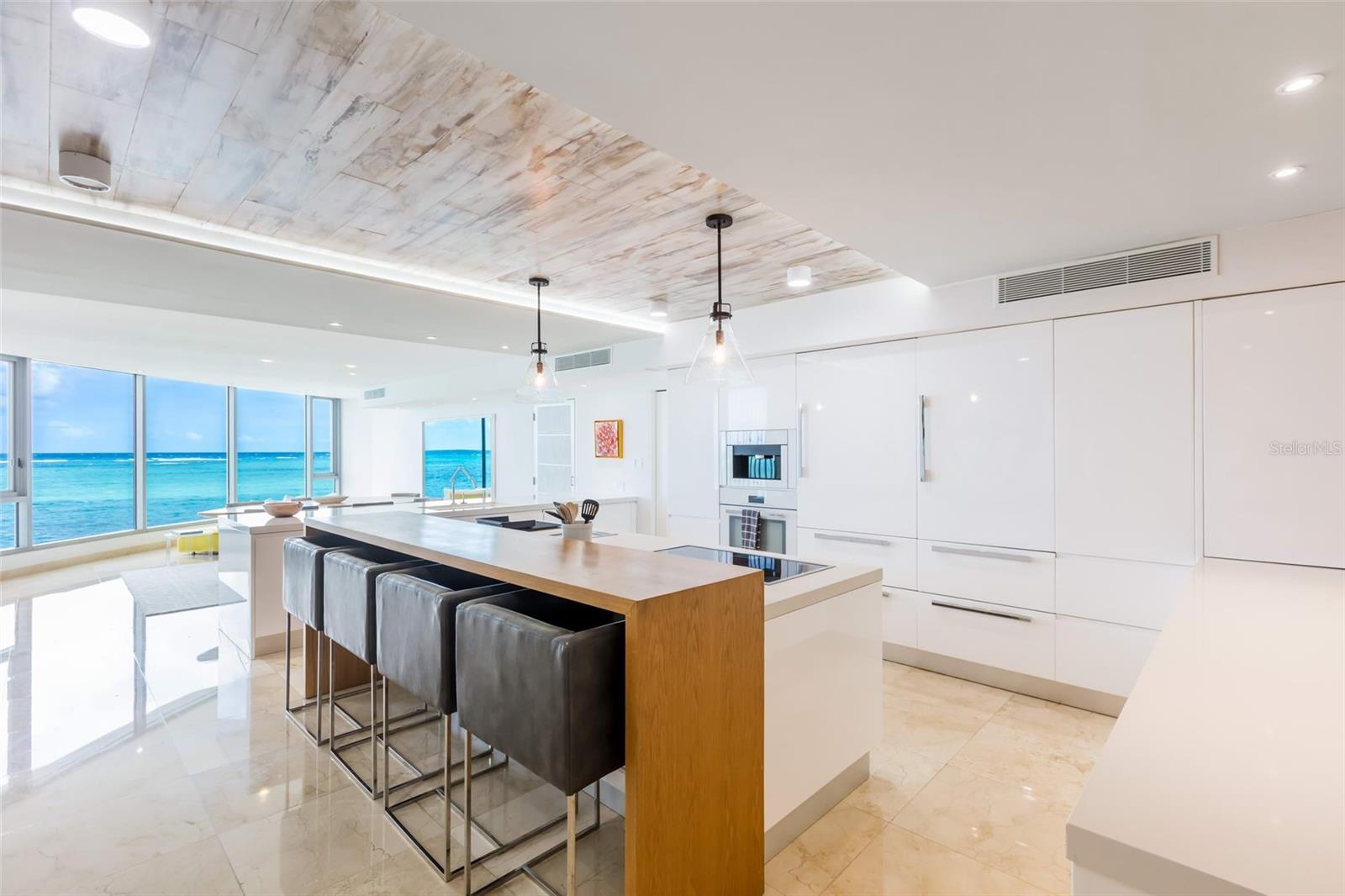 This spectacular oceanfront penthouse boasts glamour and charm, offering stunning ocean views from the moment you step into the residence.
With 3,232 square feet, it has a total of 3 bedrooms including a master suite with breathtaking view, 3 bathrooms, a powder room and 3 parking spaces equipped with one Porsche EV charger.
Floor to ceiling glass expose dramatic views of the Atlantic Ocean pouring sunlight into the home throughout the day. The welcoming state-of-the-art open kitchen outfitted with custom cabinetry includes all high-end appliances.
Its luxury primary suite features a private terrace that showcases clear water views that can be enjoyed all the way in from its spacious bathroom.
Azure Beach is an oceanfront resort-style development with luxurious rooftop outdoor amenities, located at the gated Almendro Street in Punta Las Marias.
An impressive and spacious rooftop terrace with infinity pool, terraces and kitchen area to entertain all guests, offers the perfect spot to enjoy dramatic sunrises and sunsets.
Built: 2010 # Stories: 4 # Units: 8 # Elevators: 2 ~ Full Backup Generator ~ Water Cistern ~ Resort Style Rooftop Terrace ~ Infinity Pool ~ BBQ |||||
Experience the ultimate lifestyle and luxury at Azure Beach!